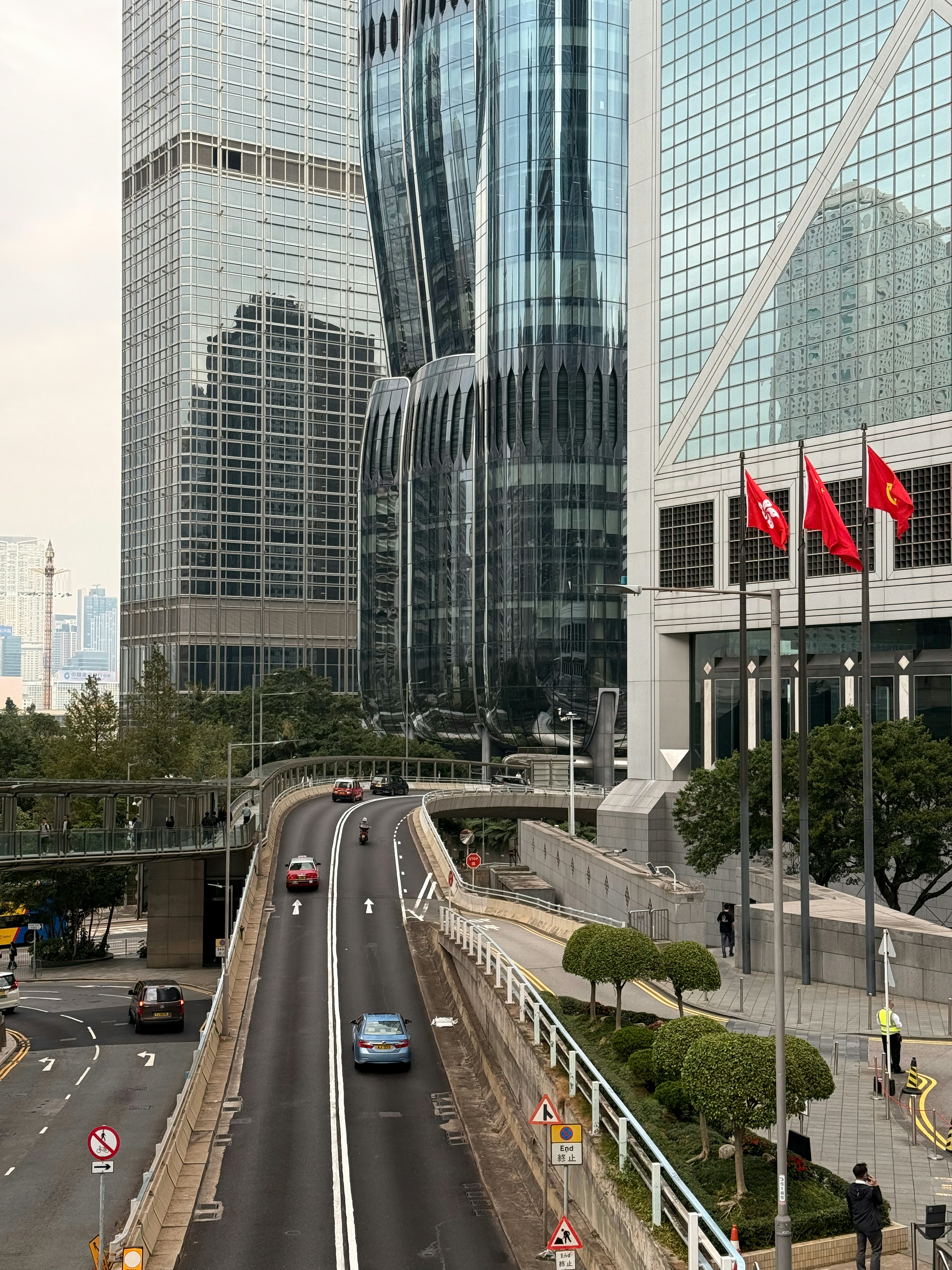 Modern skyscrapers and a road with cars in a city