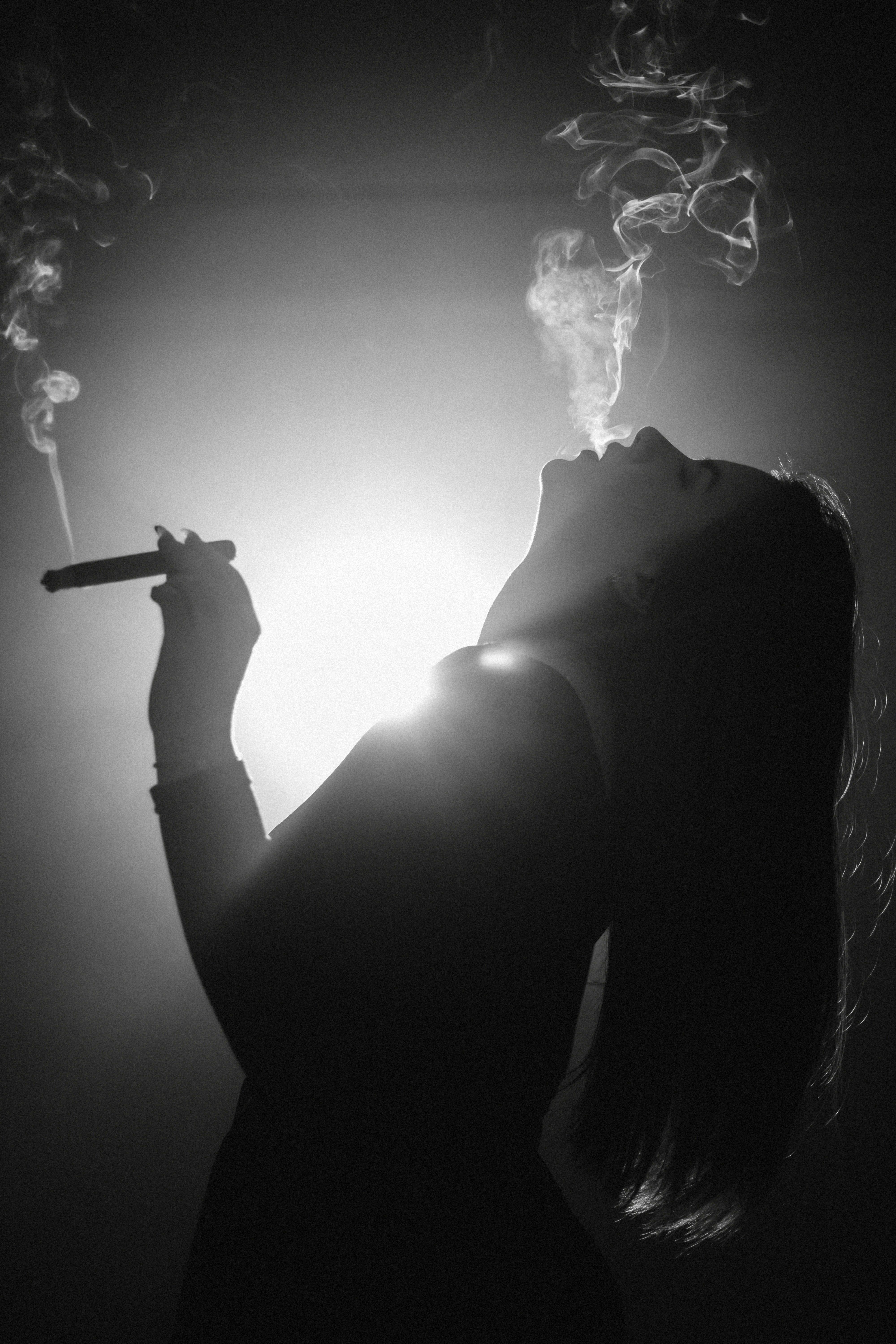 Silhouette of a woman smoking a cigar