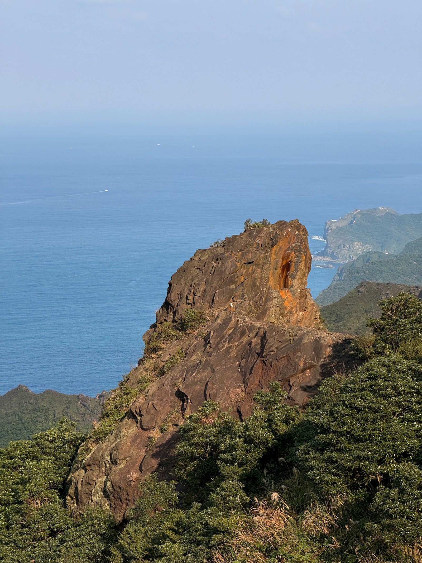 Vacation destinations - coastal cliff overlook with mountains and ocean