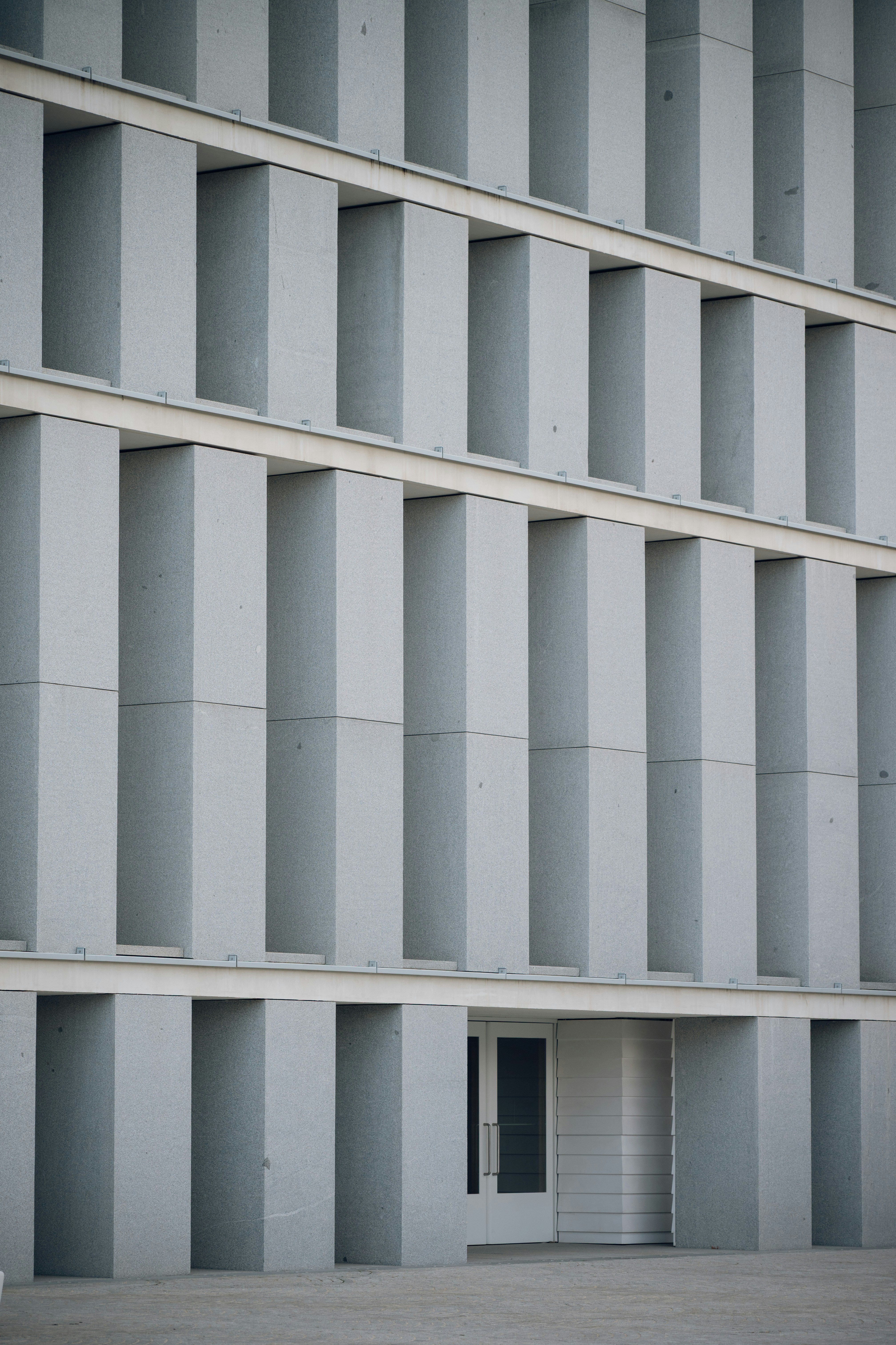 Modern building facade with repeating vertical elements.