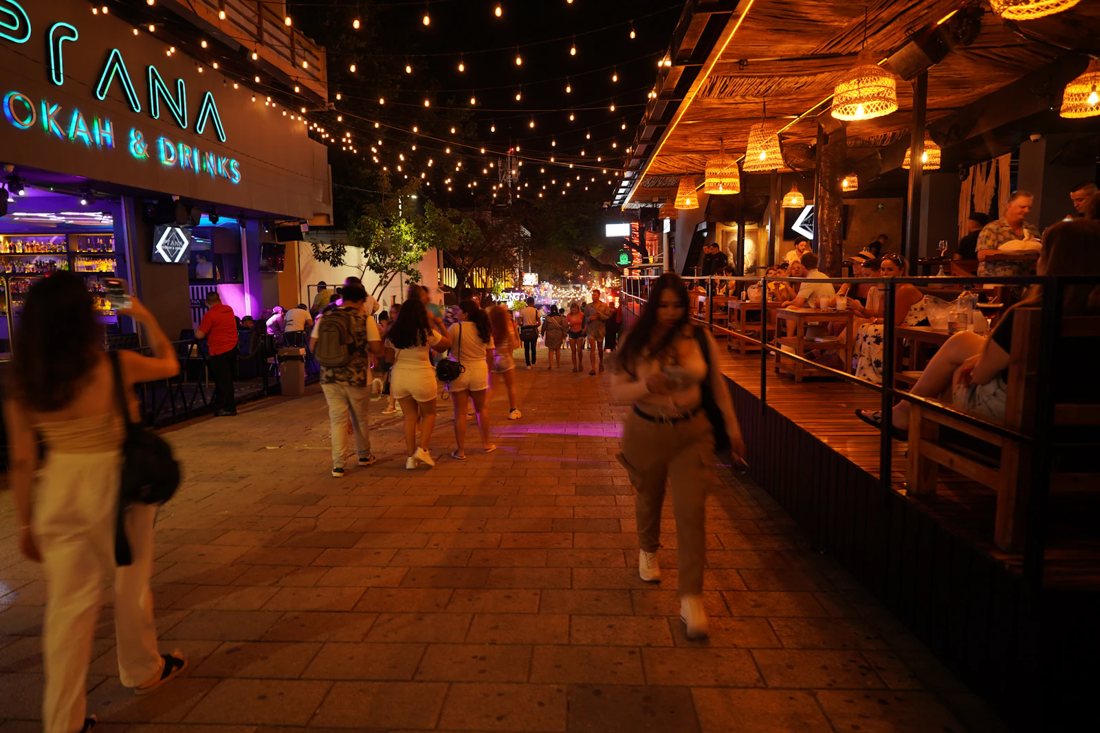 An open pedestrian plaza buzzing at night — Soho Square energy.
