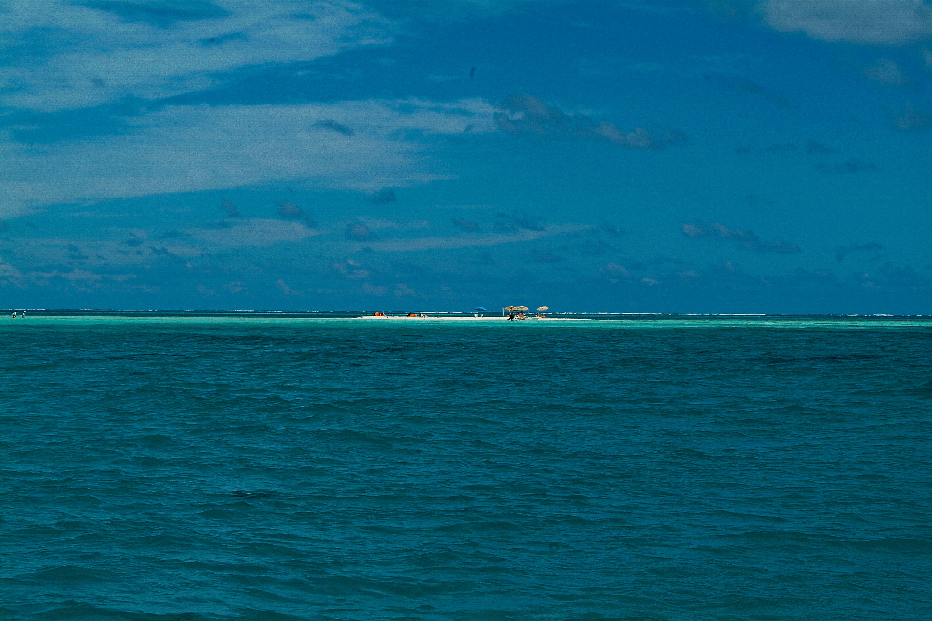 Distant island with buildings surrounded by turquoise water
