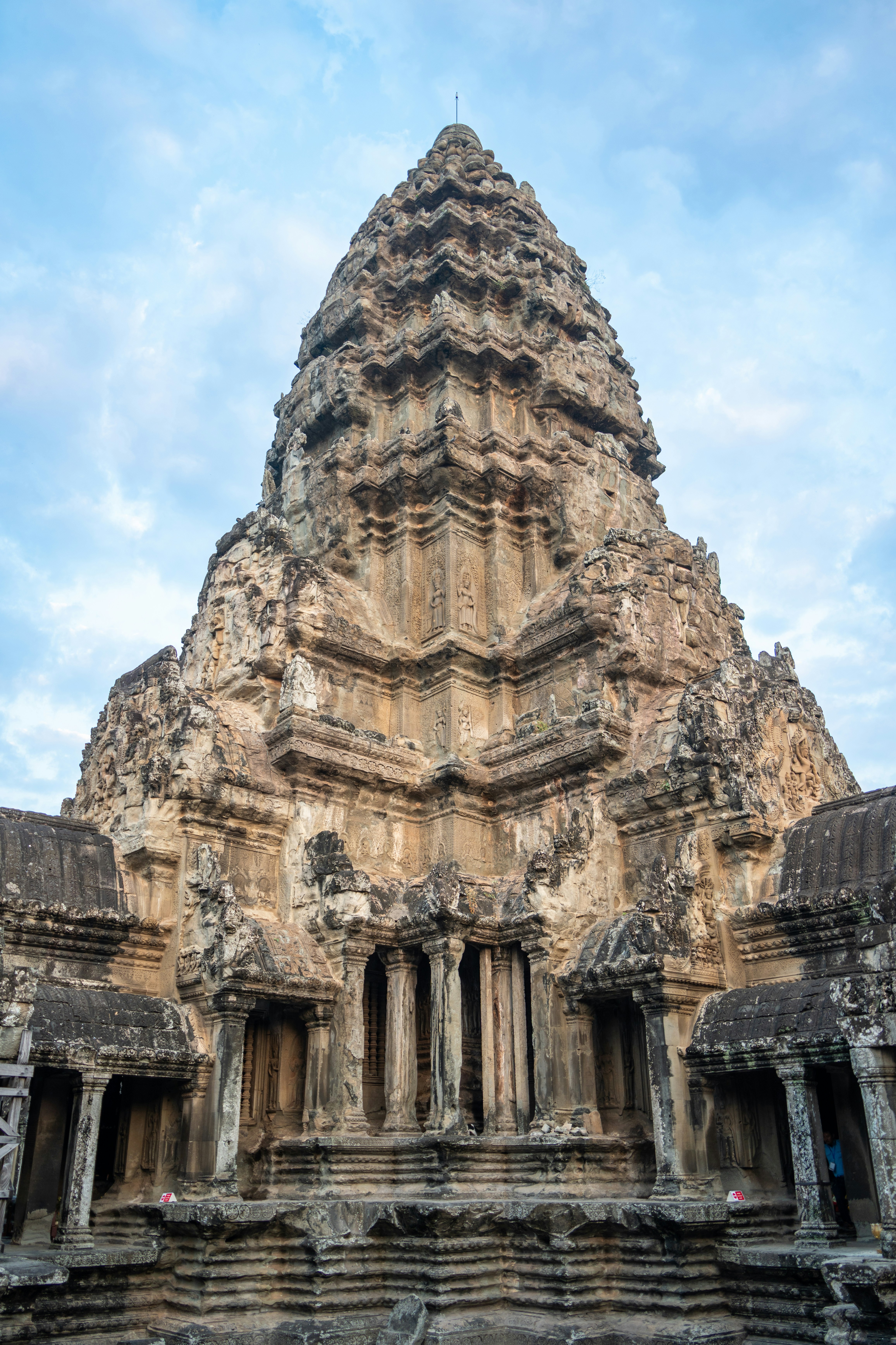 Ancient stone temple tower against a cloudy sky
