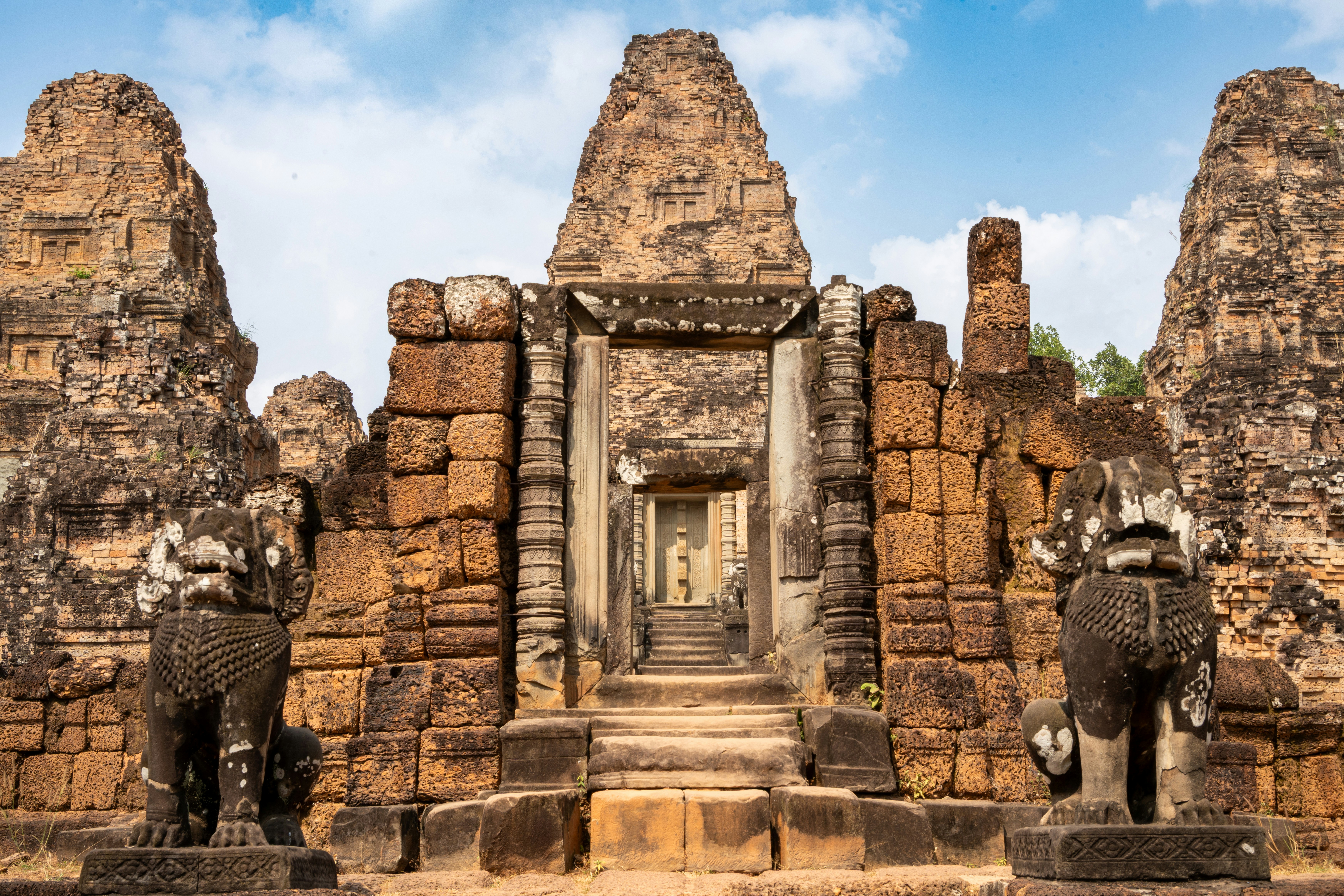 Ancient stone temple ruins with lion statues and clear sky