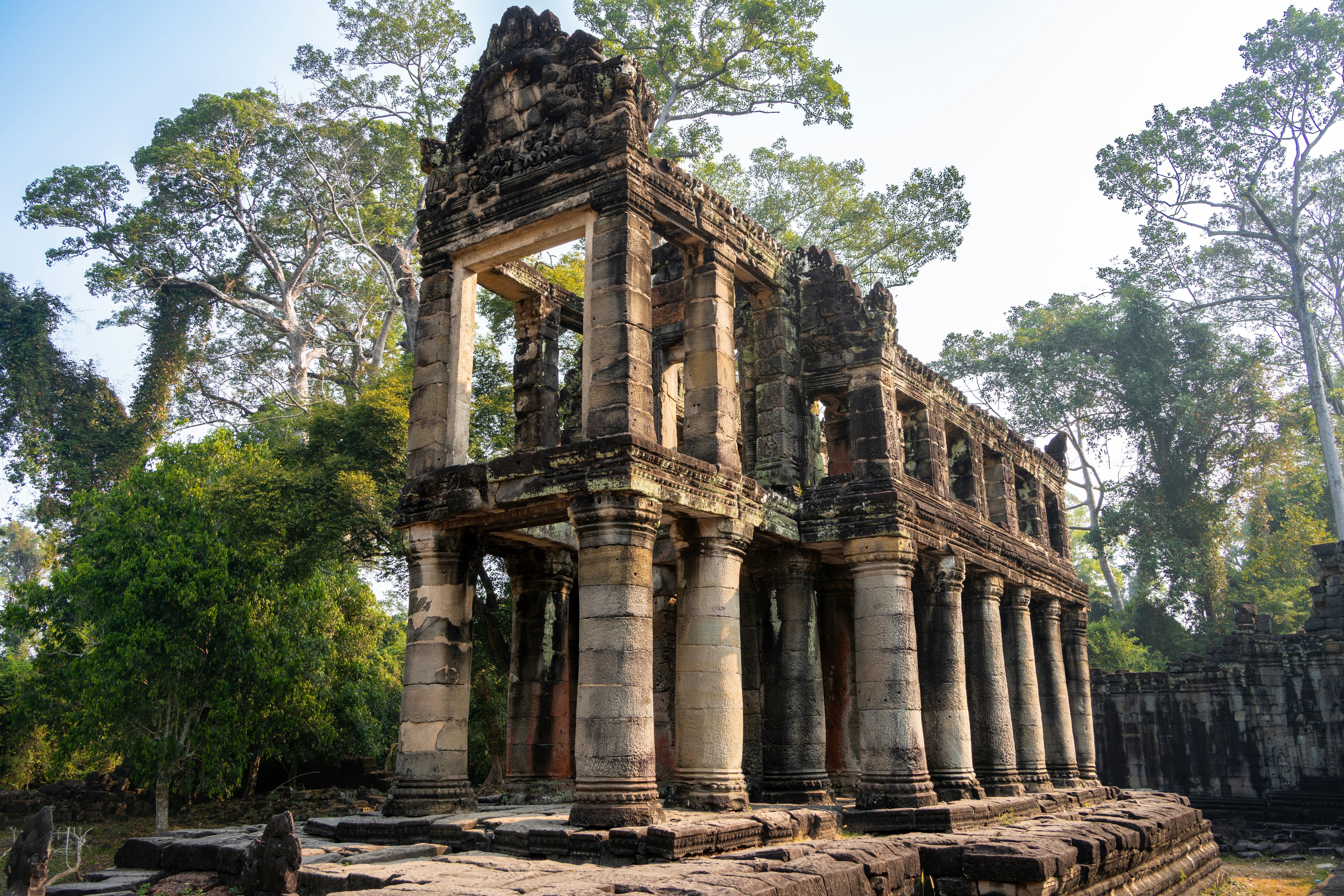Ancient stone ruins with columns in a forest