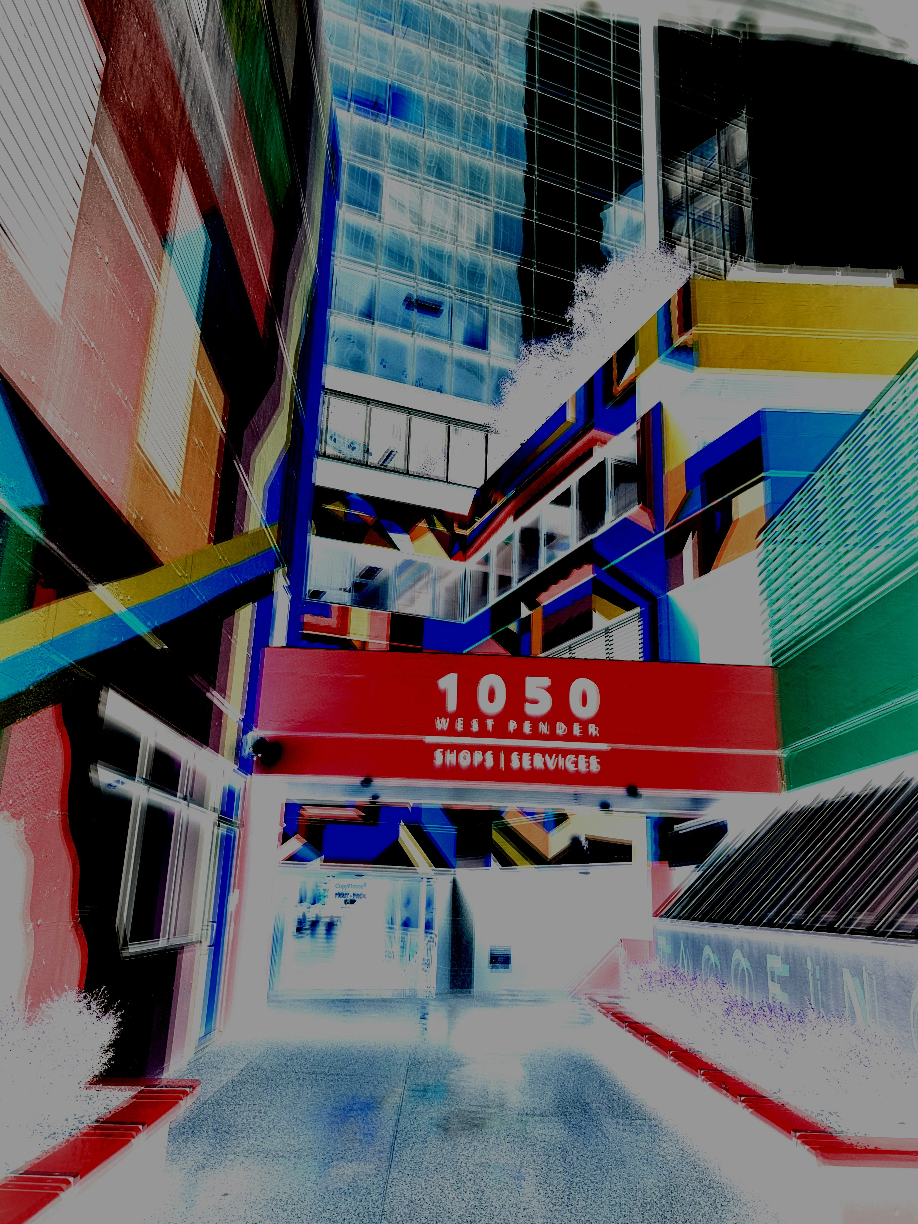 Colorful abstract buildings with a red sign.