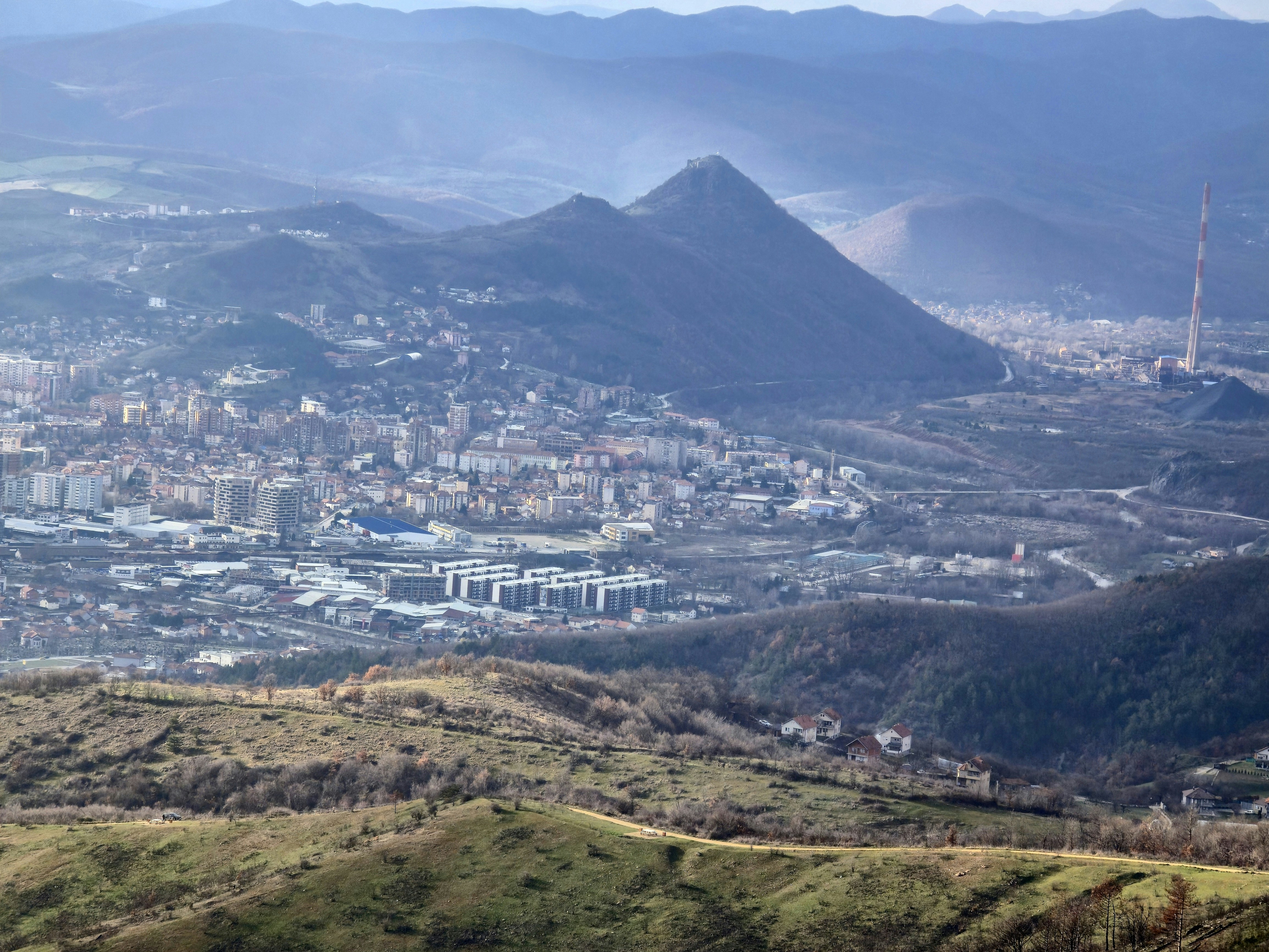 Hilly landscape with a city nestled in the valley.