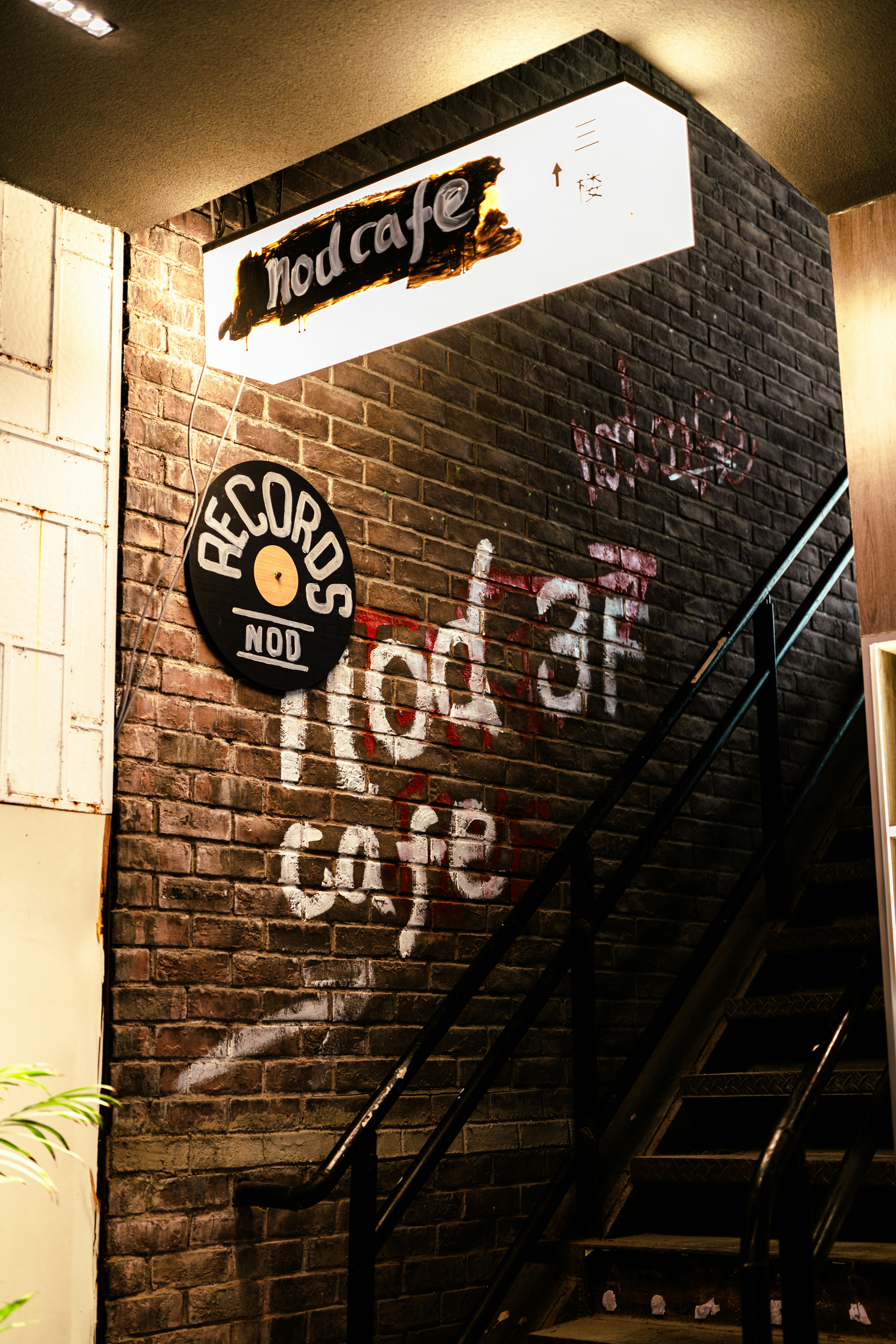 Nod cafe sign on brick wall with stairs