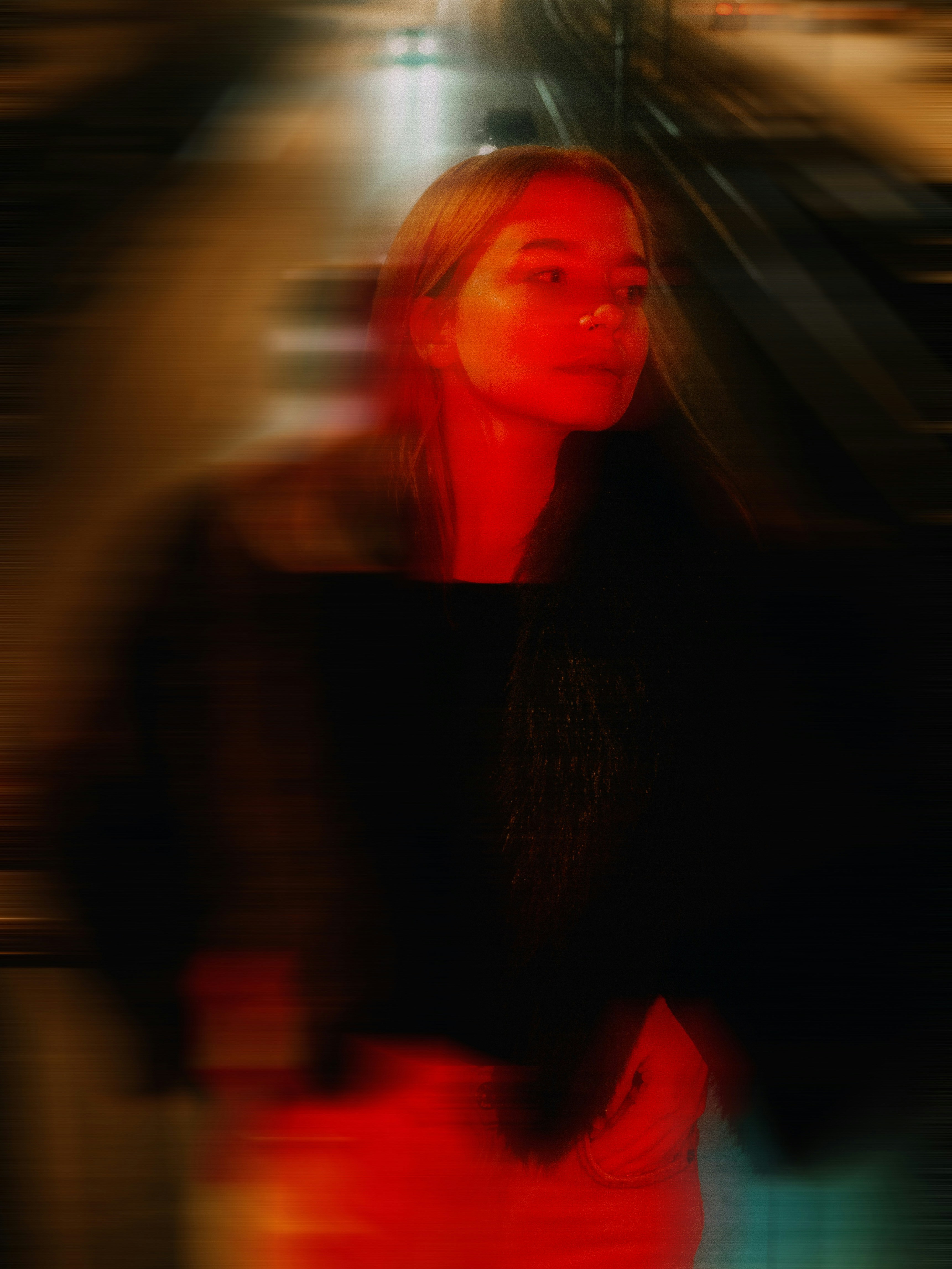 Woman illuminated by red light with motion blur