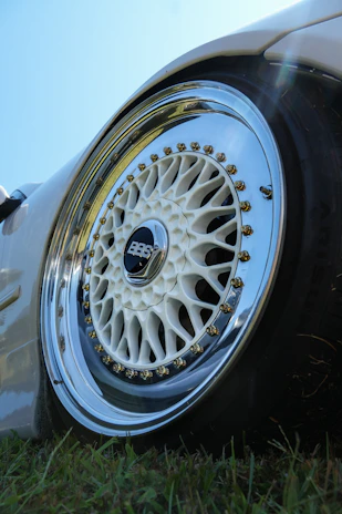 A white bbs car wheel with chrome accents