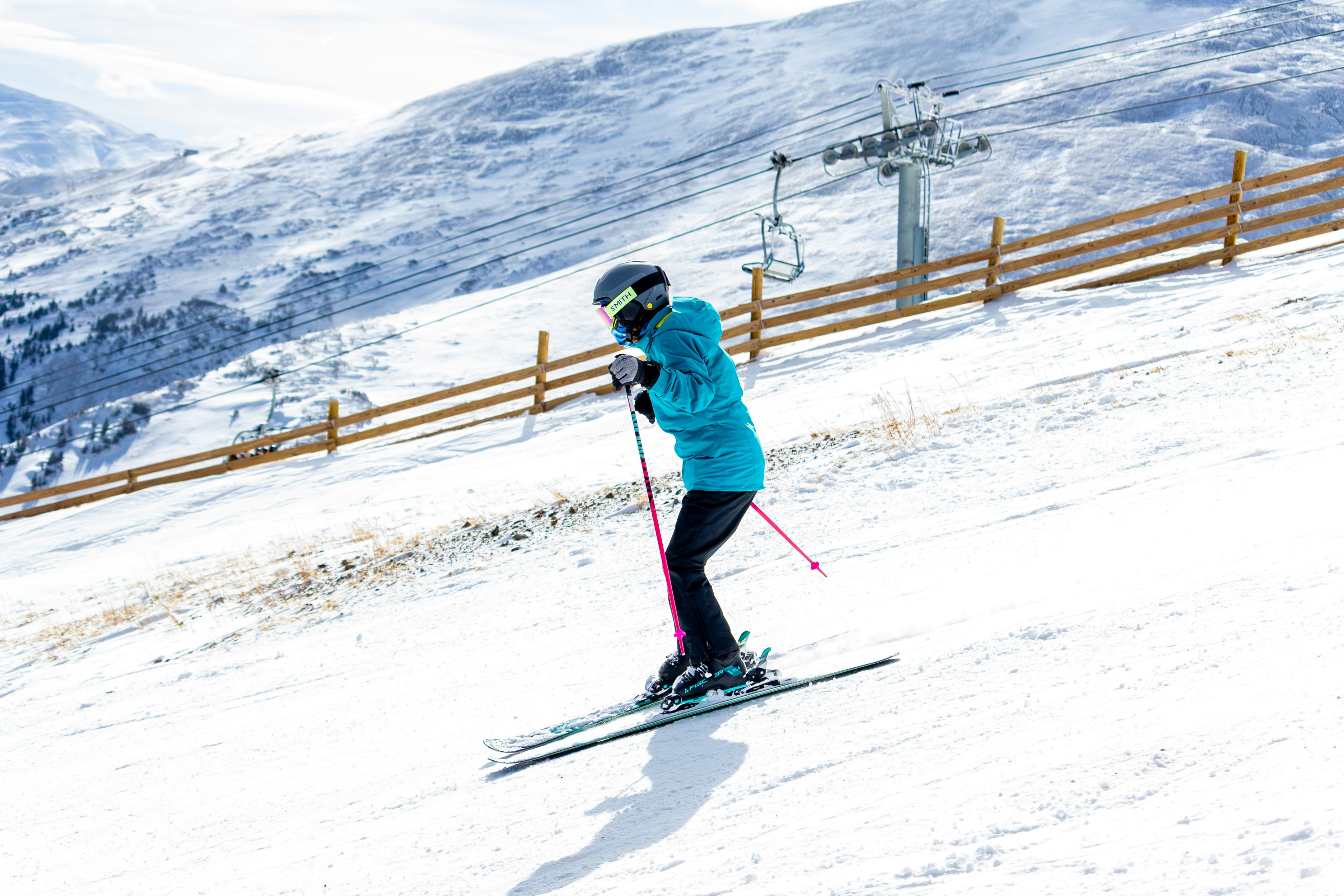 A person skiing down a snowy mountain slope.