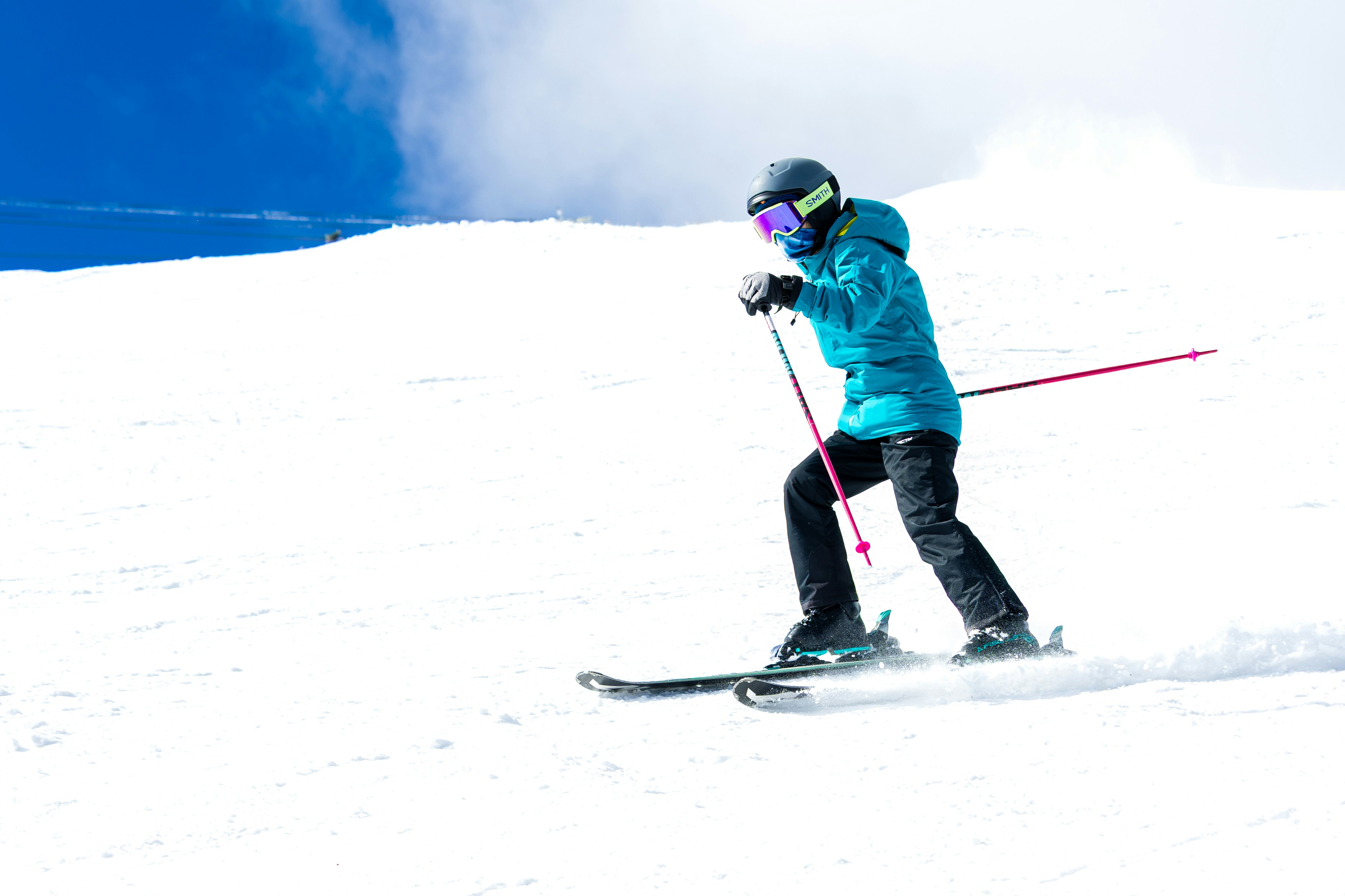 A person skiing down a snow-covered mountain slope.