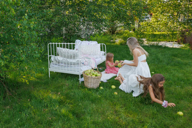 A mother and her children picking apples in a garden