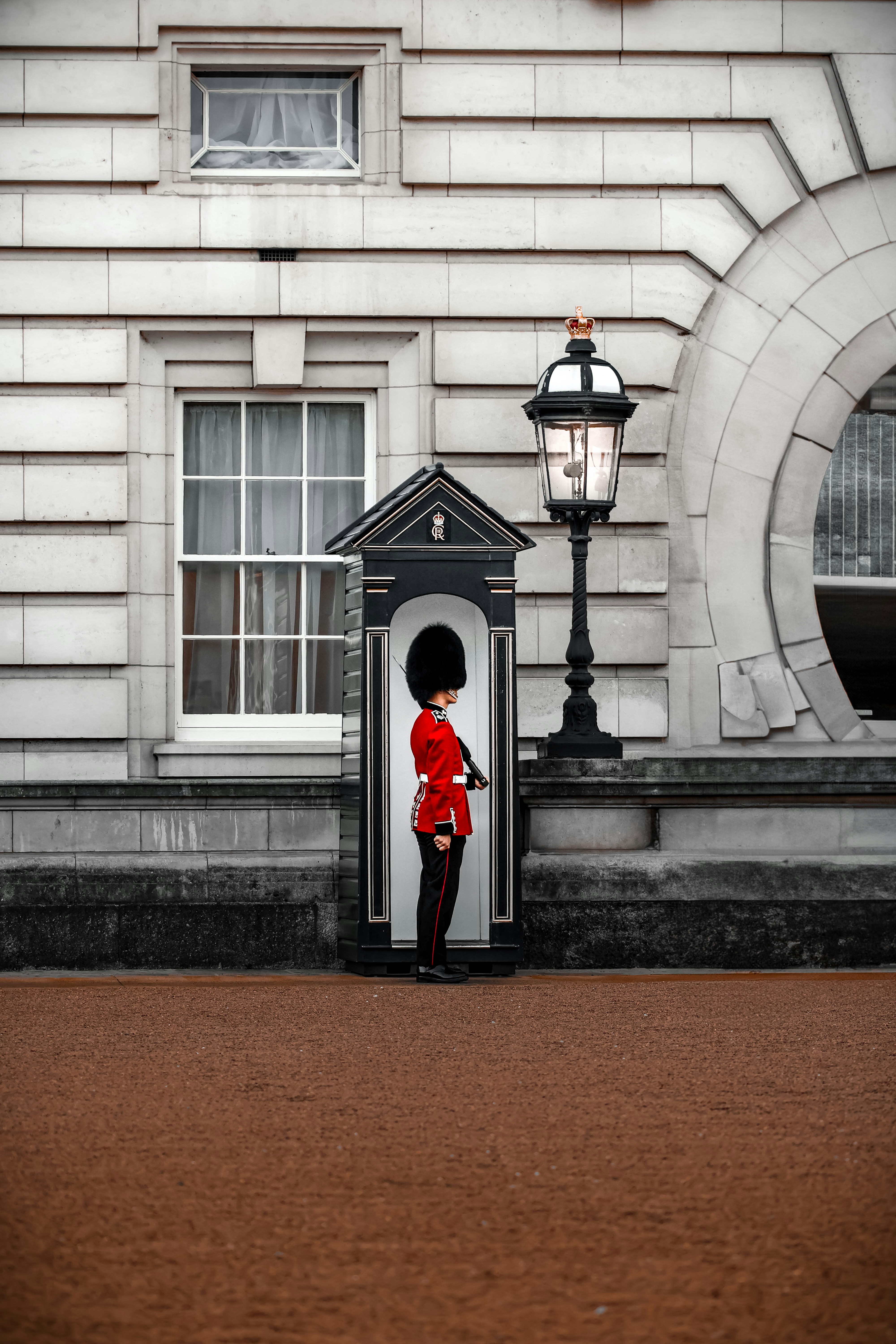A royal guard stands outside a building