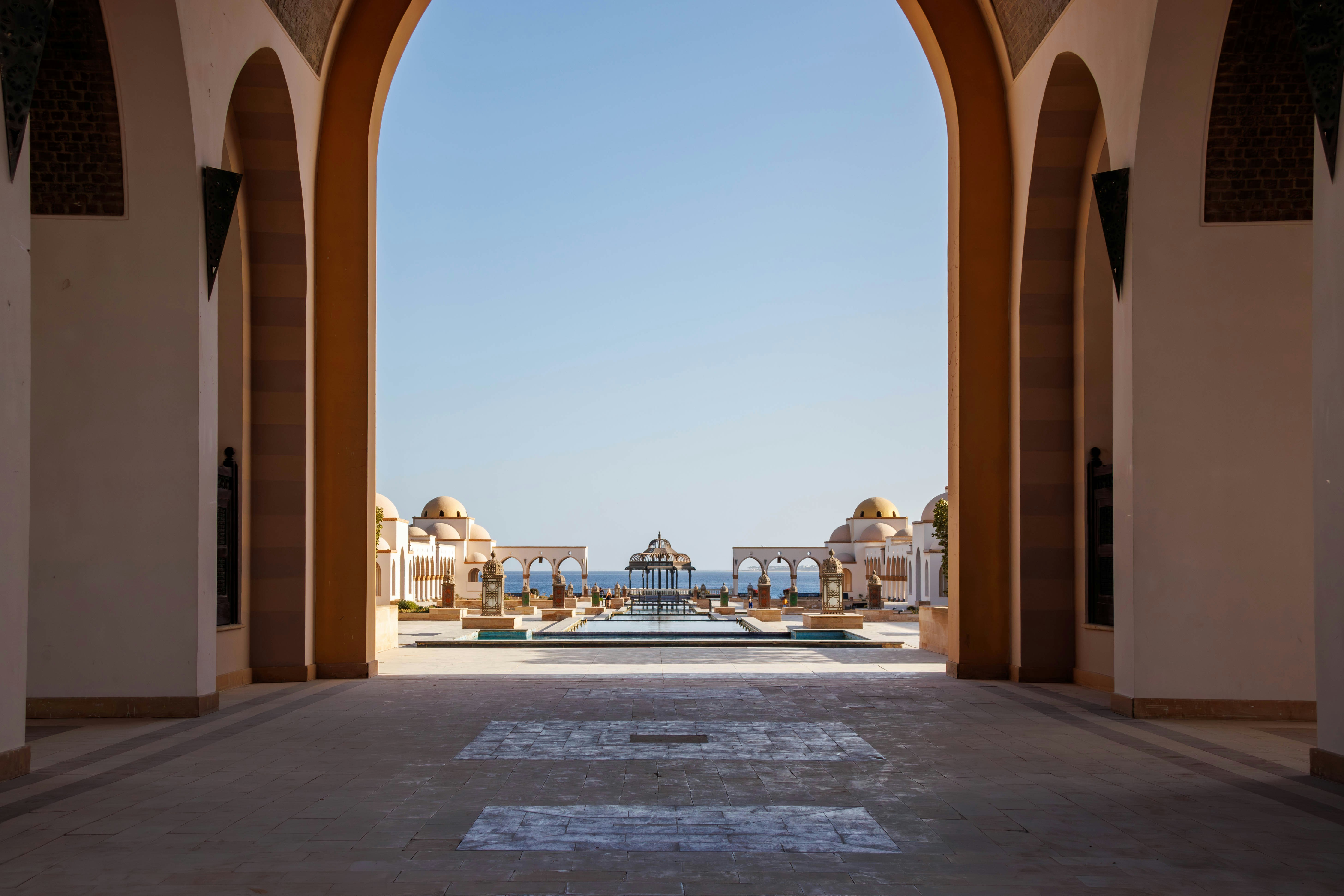 Grand archway leading to a resort with ocean view