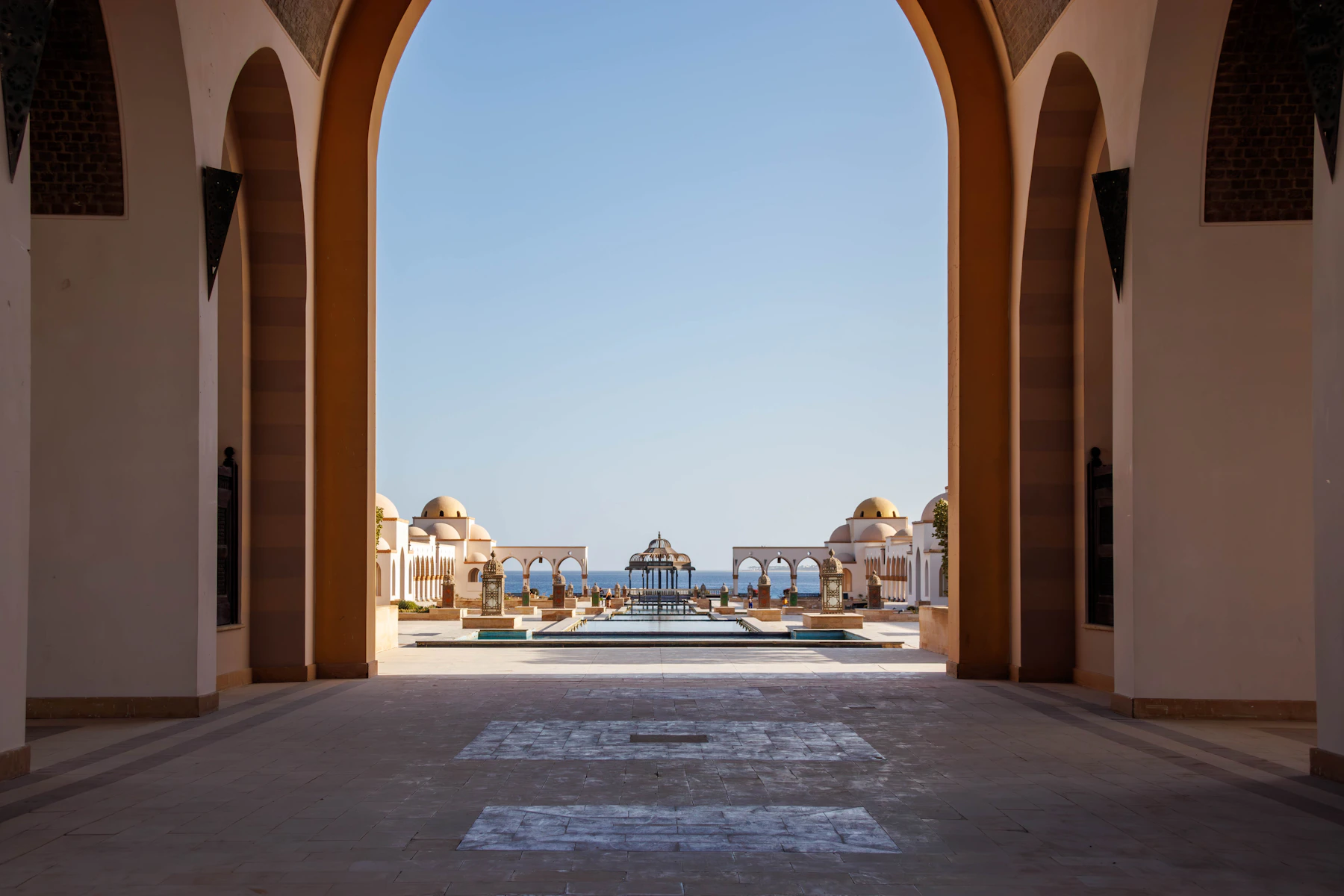 Grand archway leading to a resort with ocean view in Sahl Hasheesh