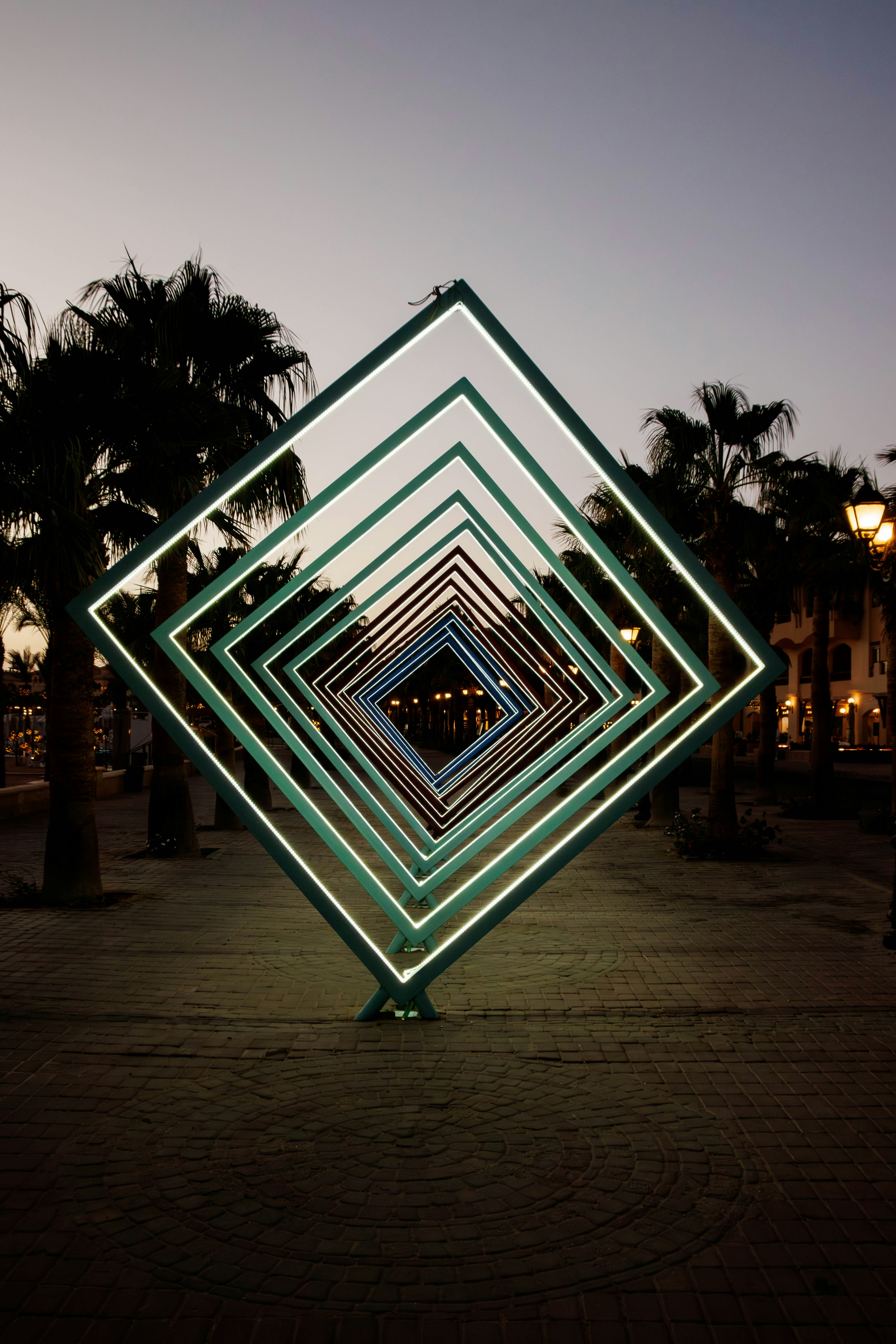 Geometric light installation in a park at dusk