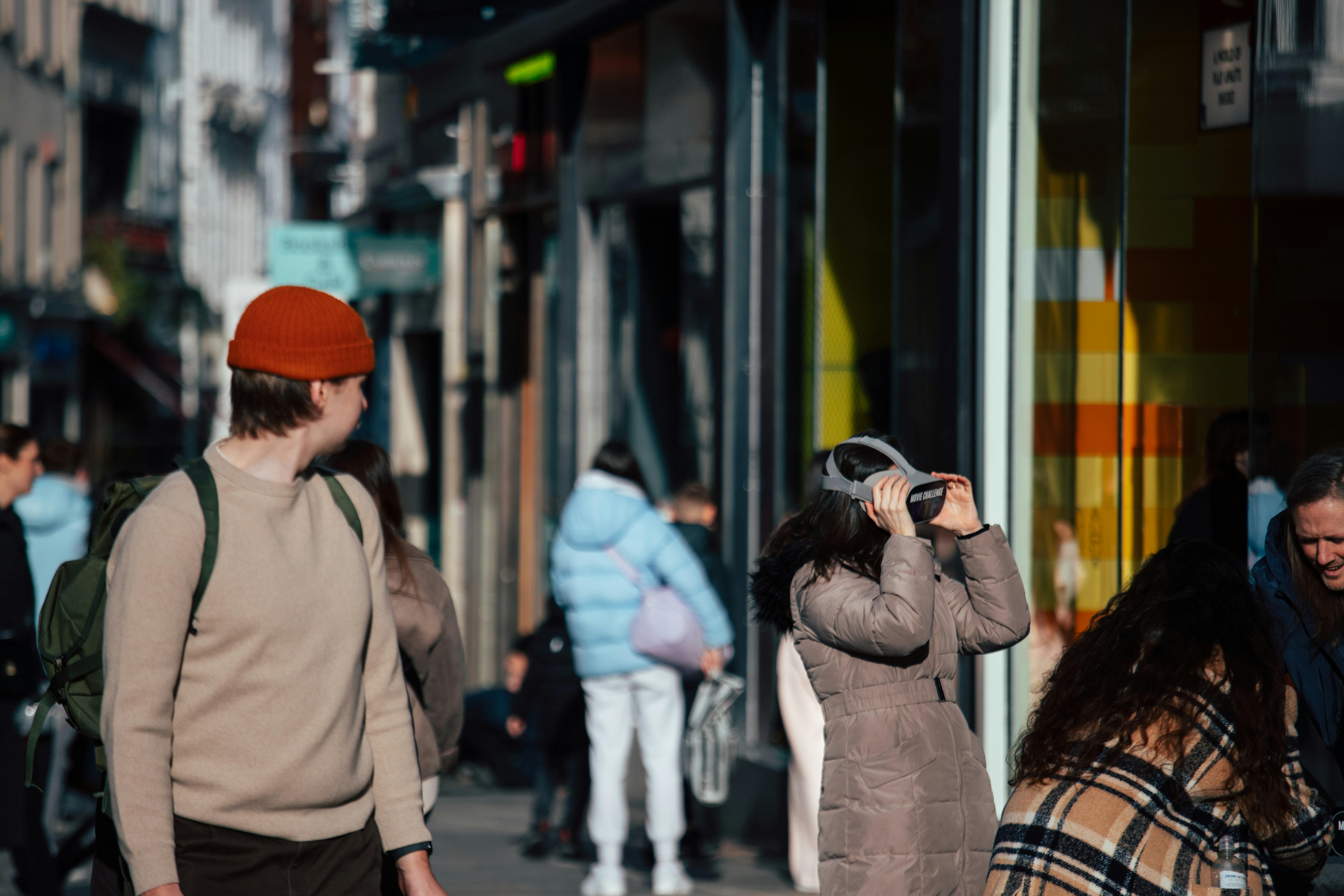 People walking on a sunny city street