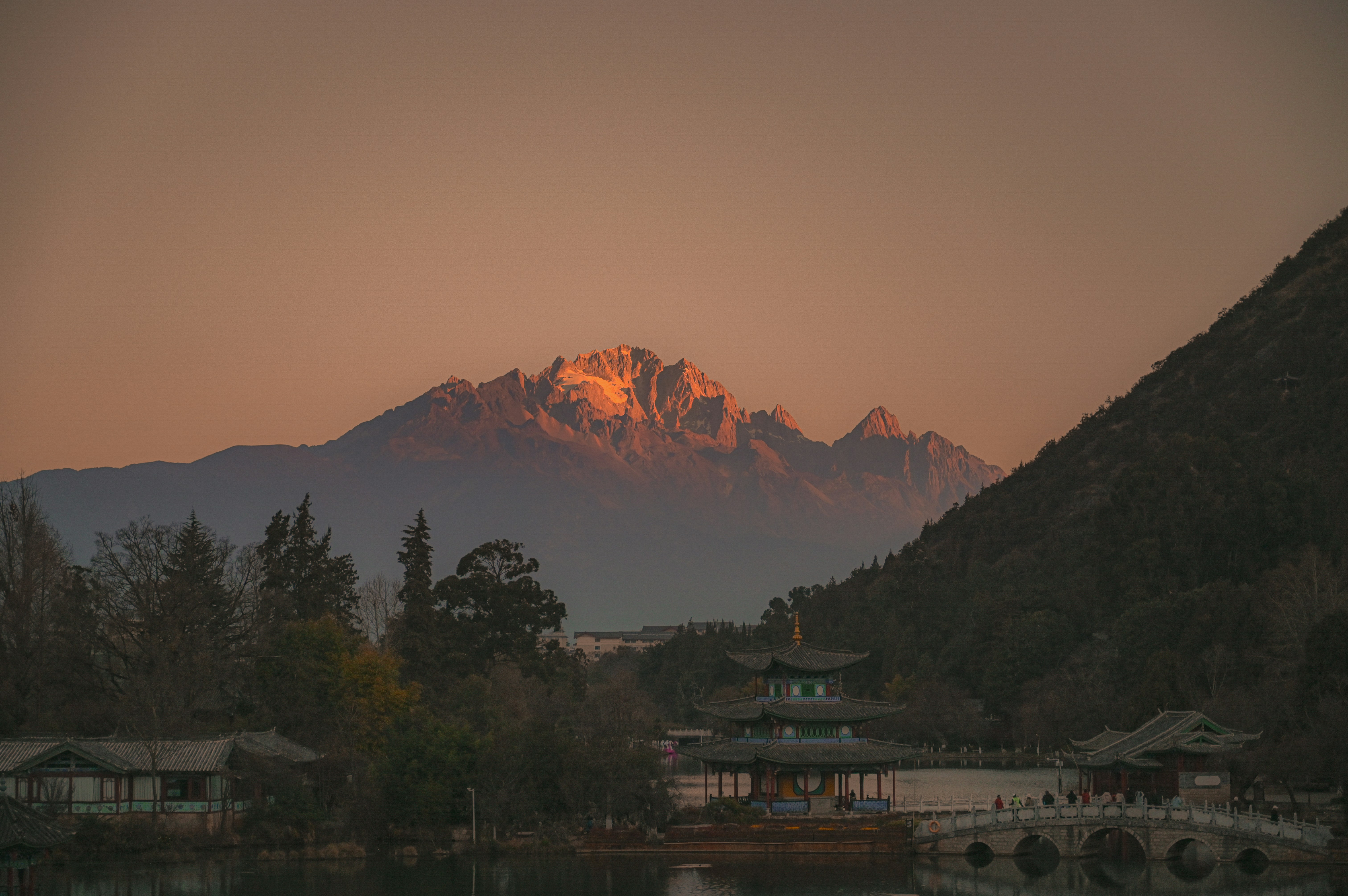 Golden mountain peak illuminated by sunset light.