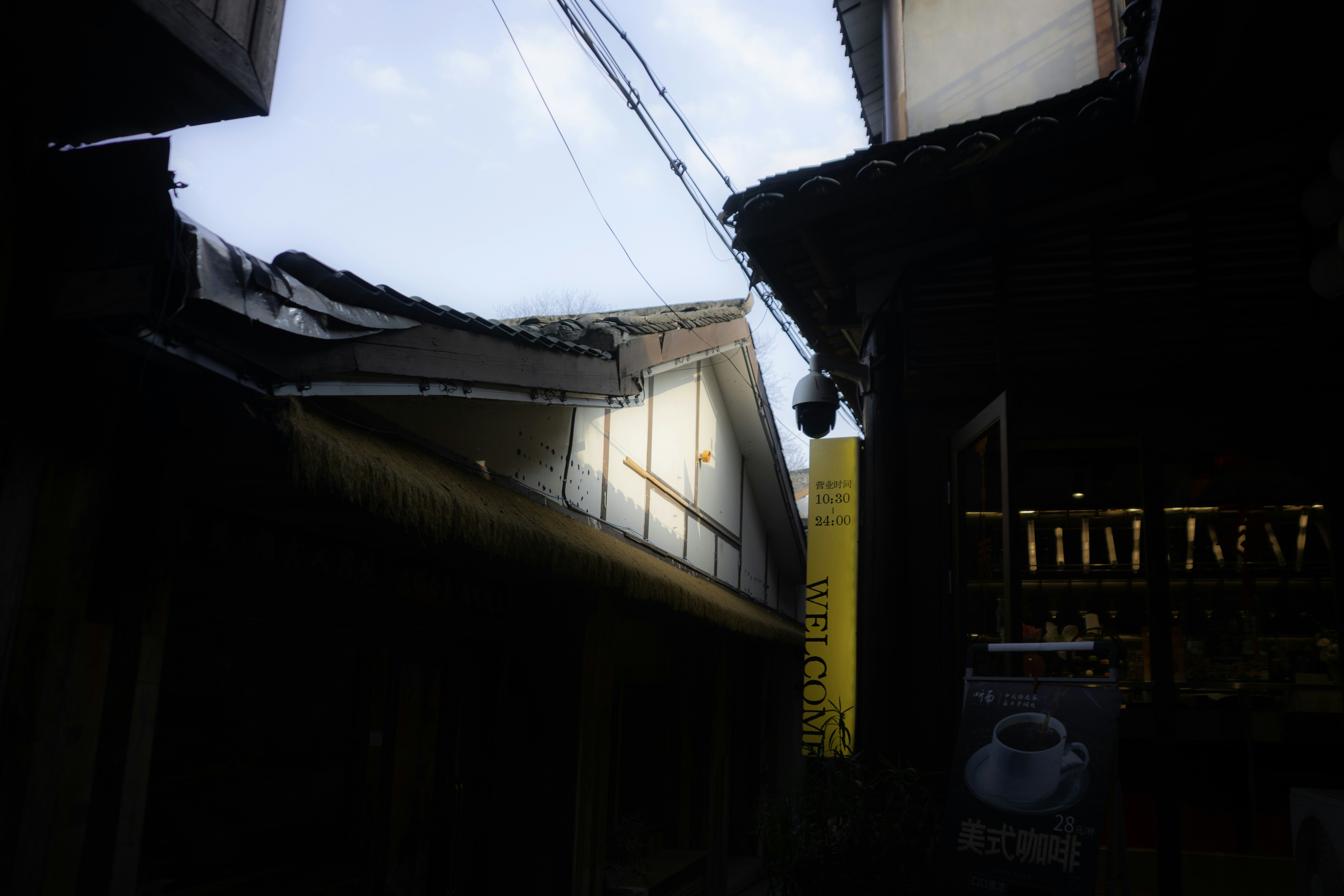 Narrow alleyway between traditional buildings under sky