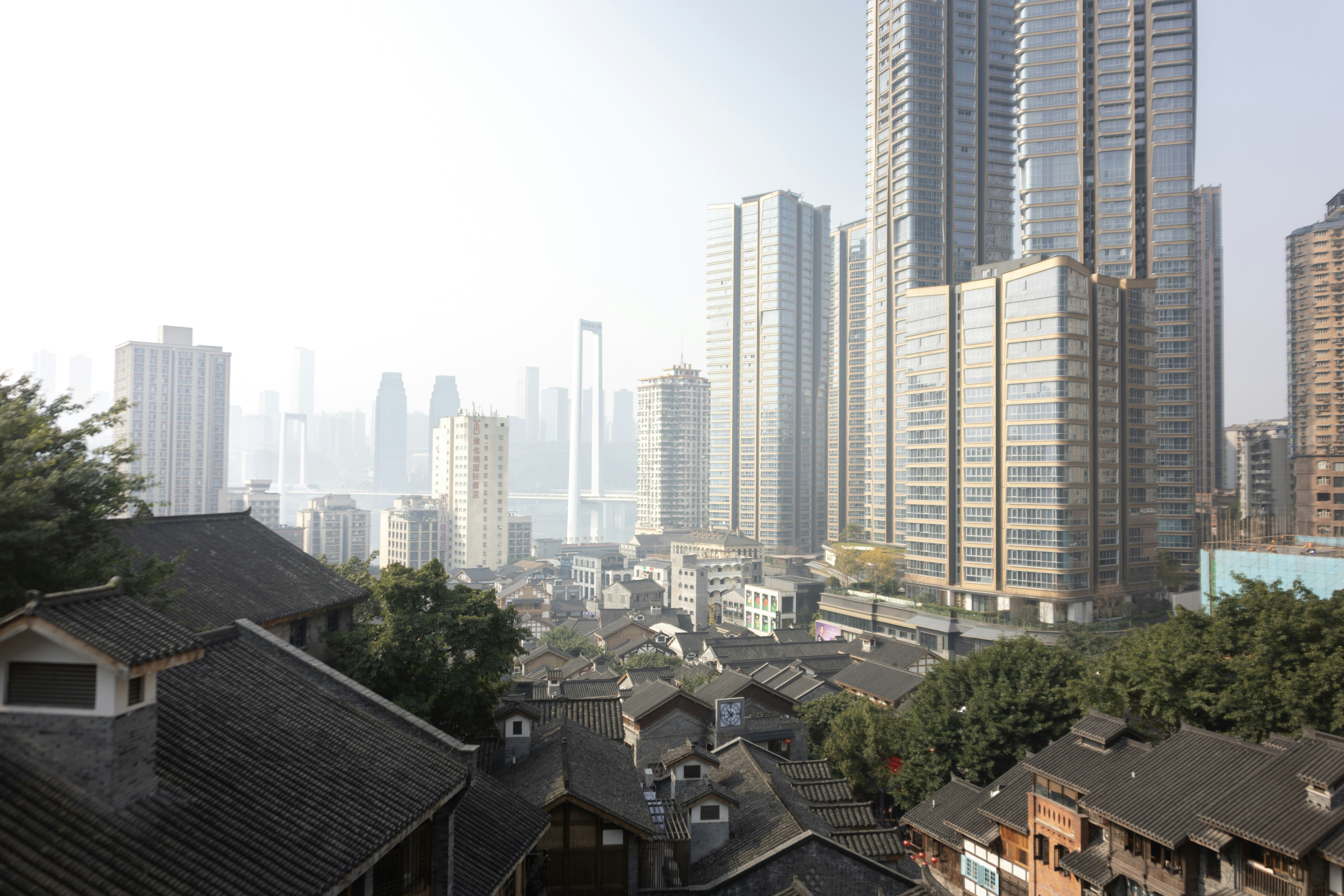 Modern skyscrapers tower over historic buildings in a city.