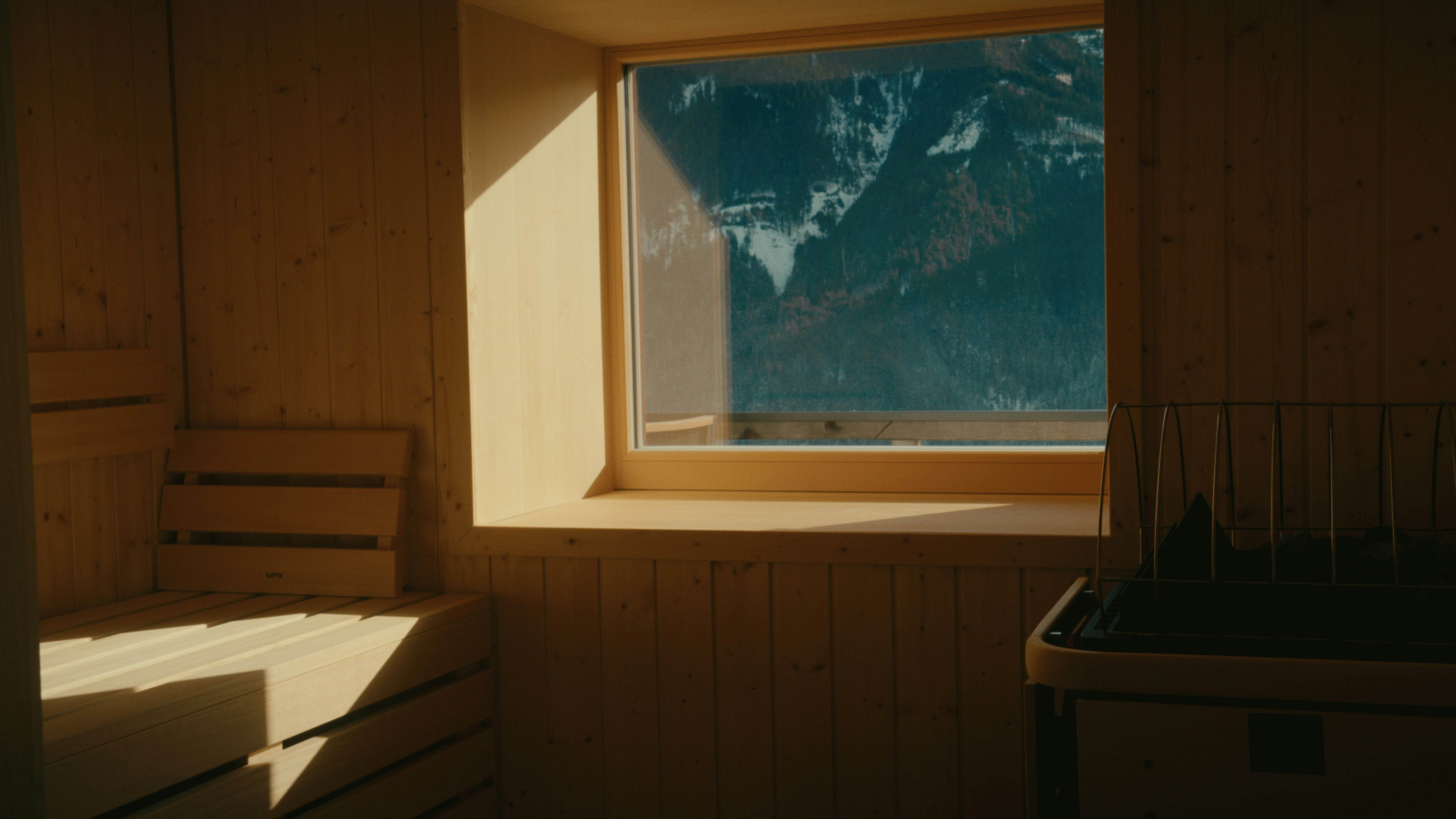 Sunlight streams into a rustic room with a mountain view.
