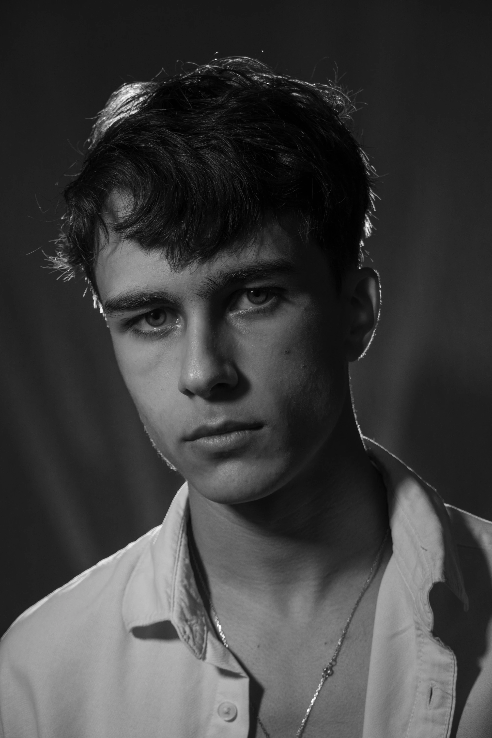 A black and white portrait of a young man