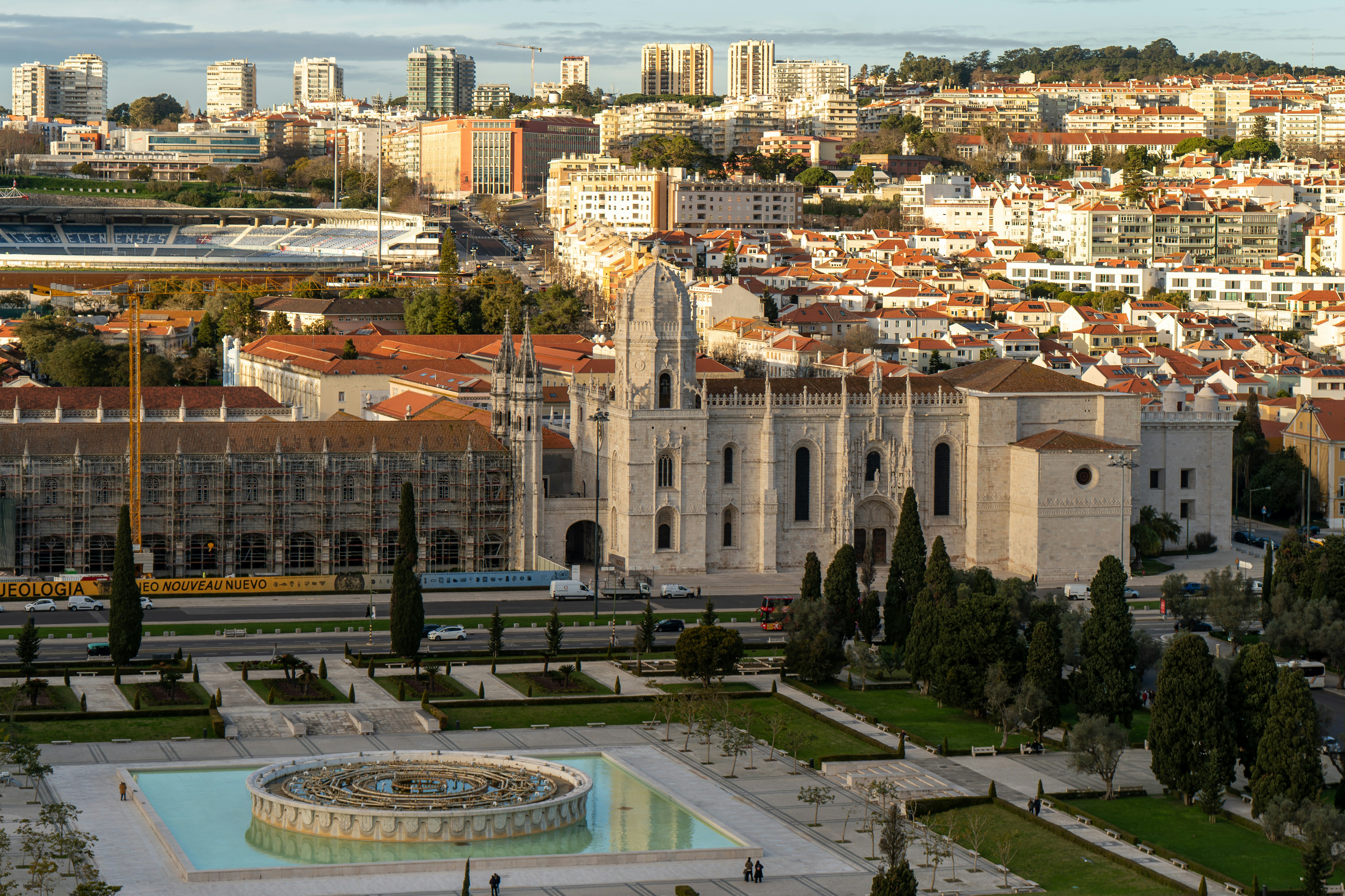 Historic monastery with city skyline and garden