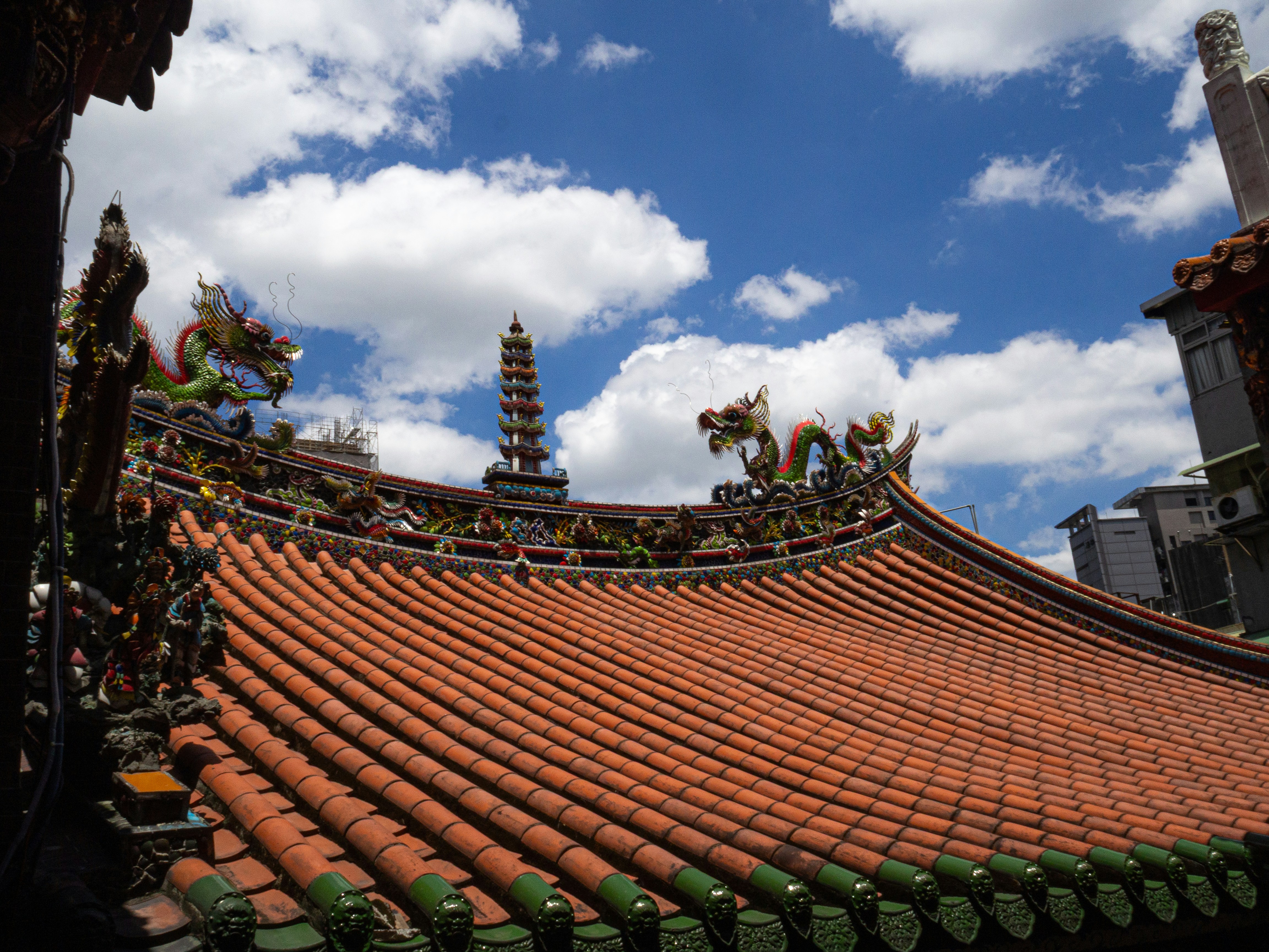 Traditional temple roof with dragon ornaments and pagoda.