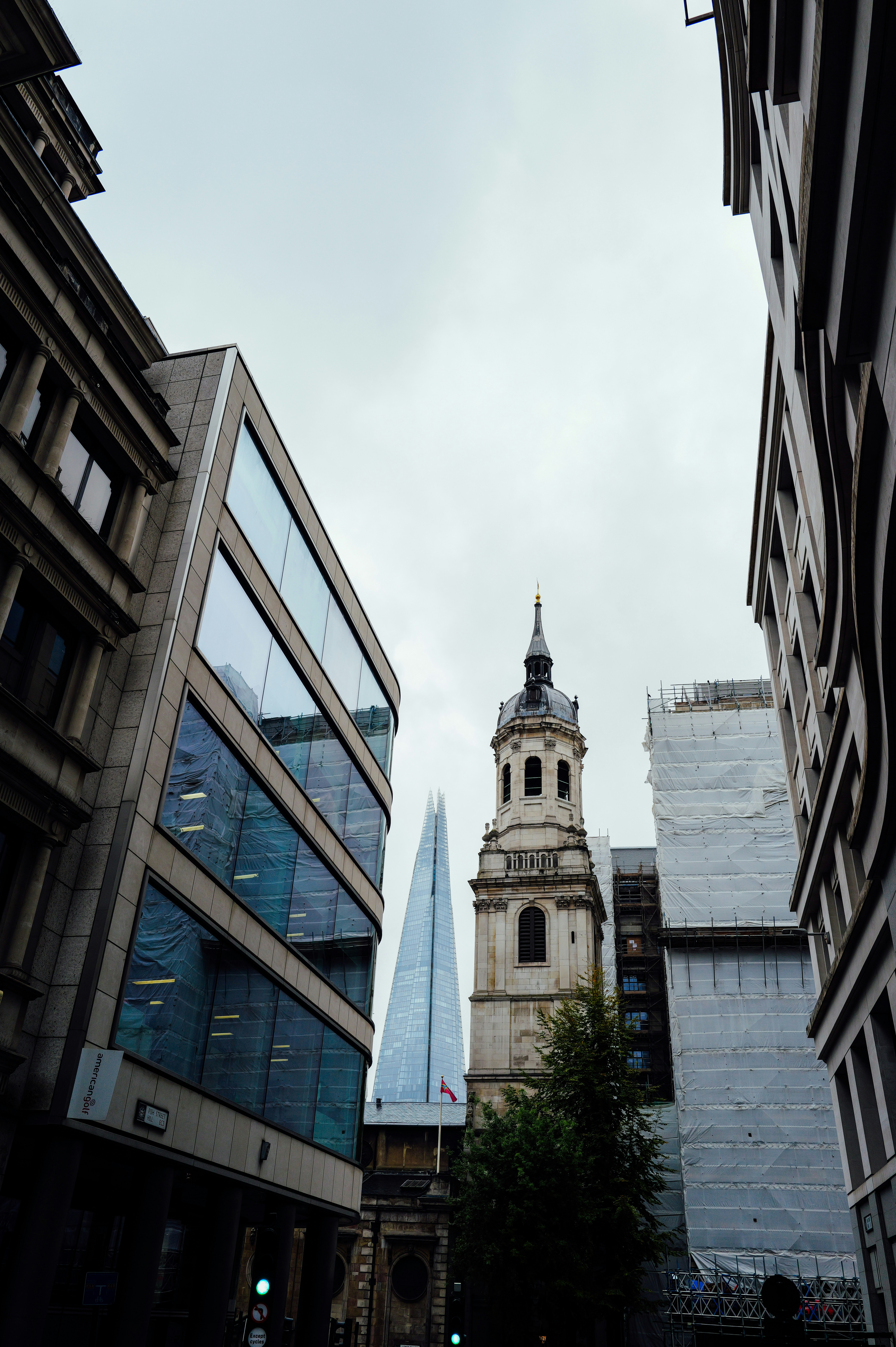 Modern and historic buildings under a cloudy sky