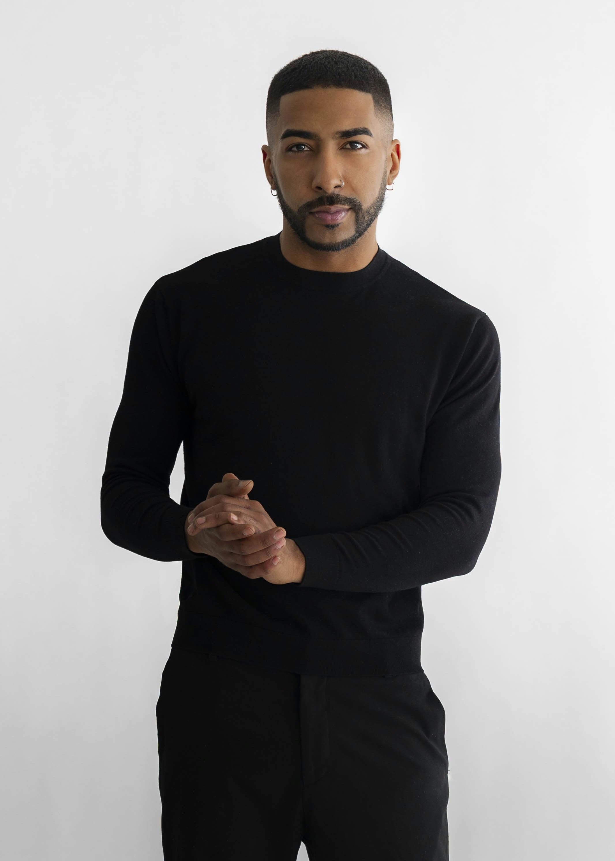 A man in a black sweater and pants