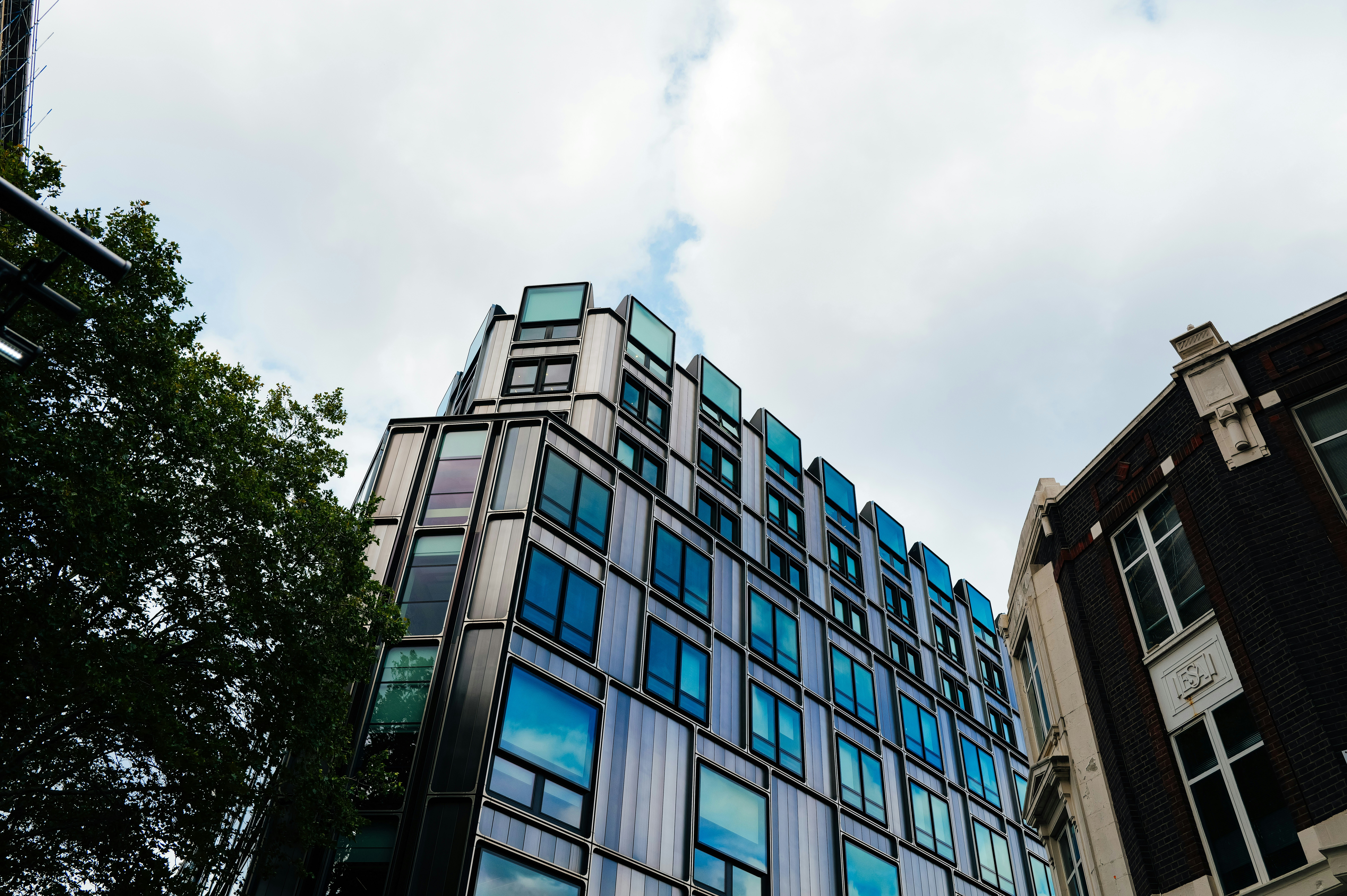 Modern glass building against a cloudy sky