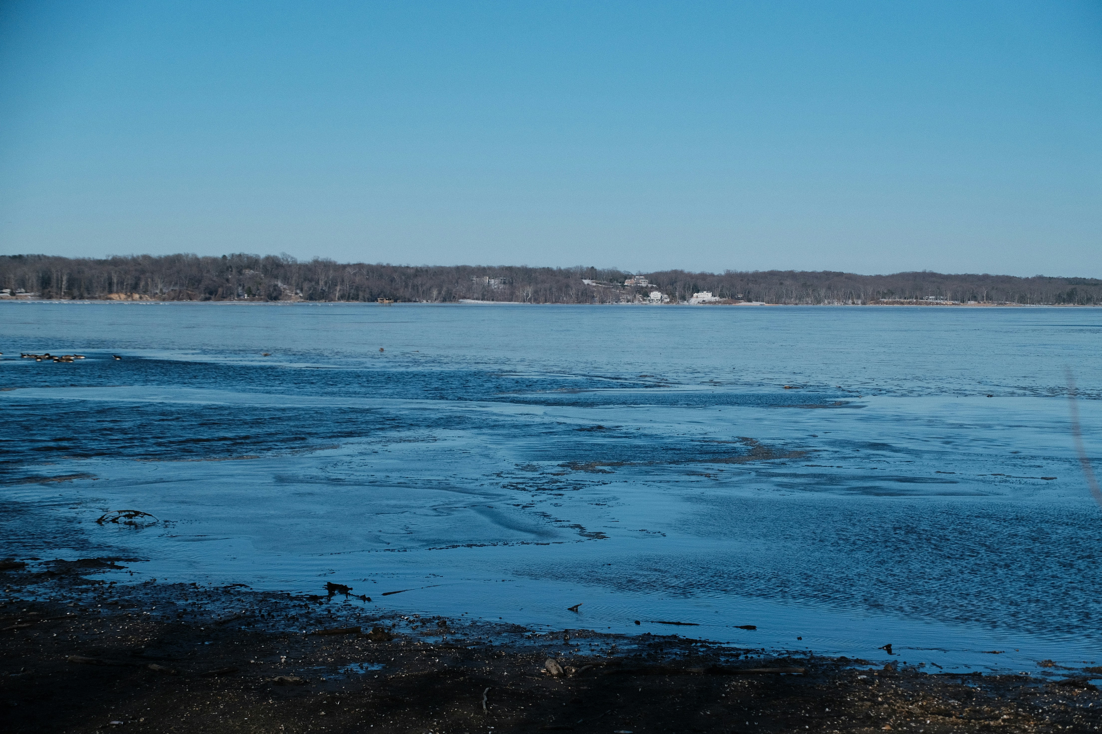 Frozen lake with a clear blue sky above.