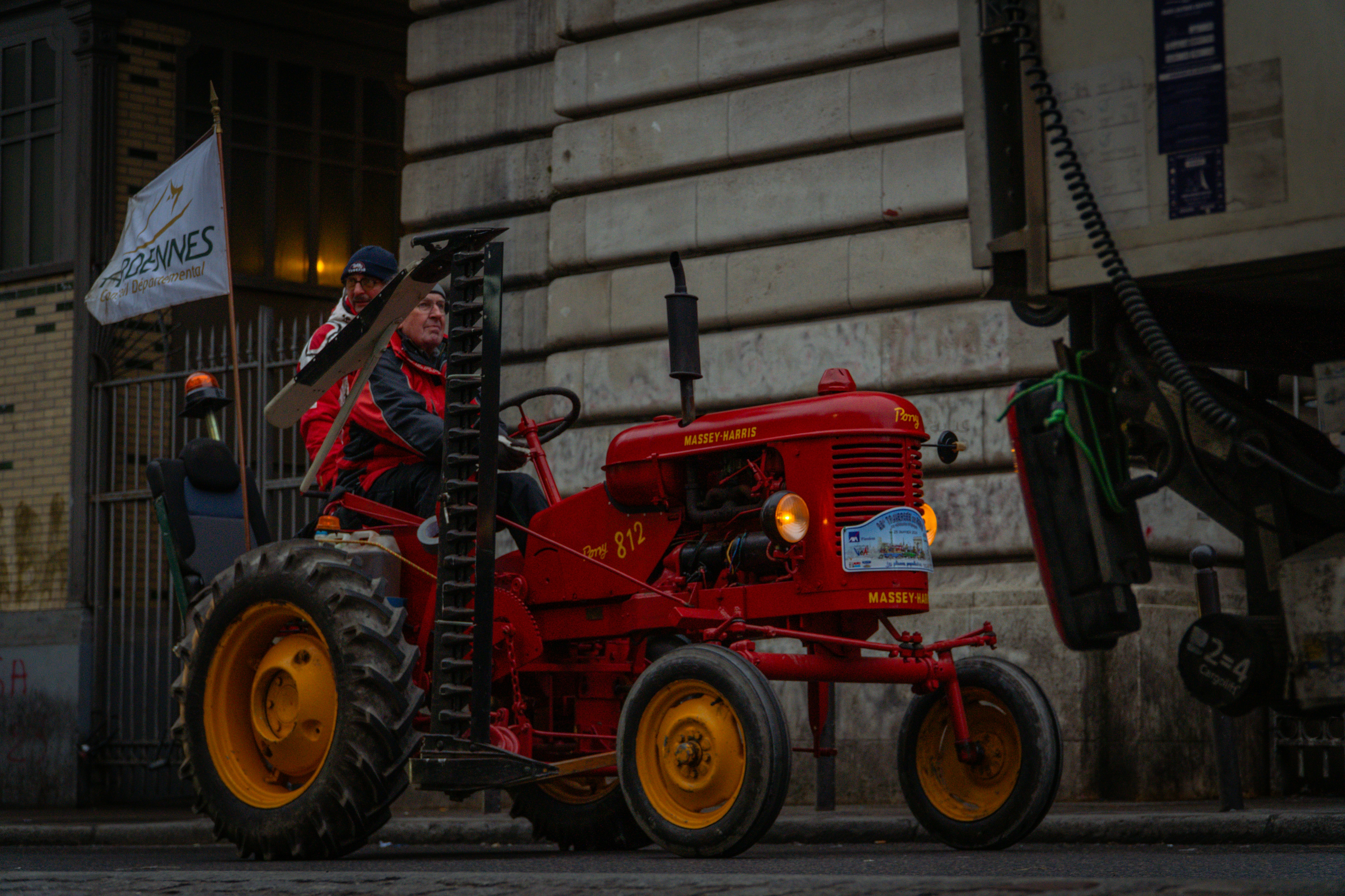 Red vintage tractor with a person driving