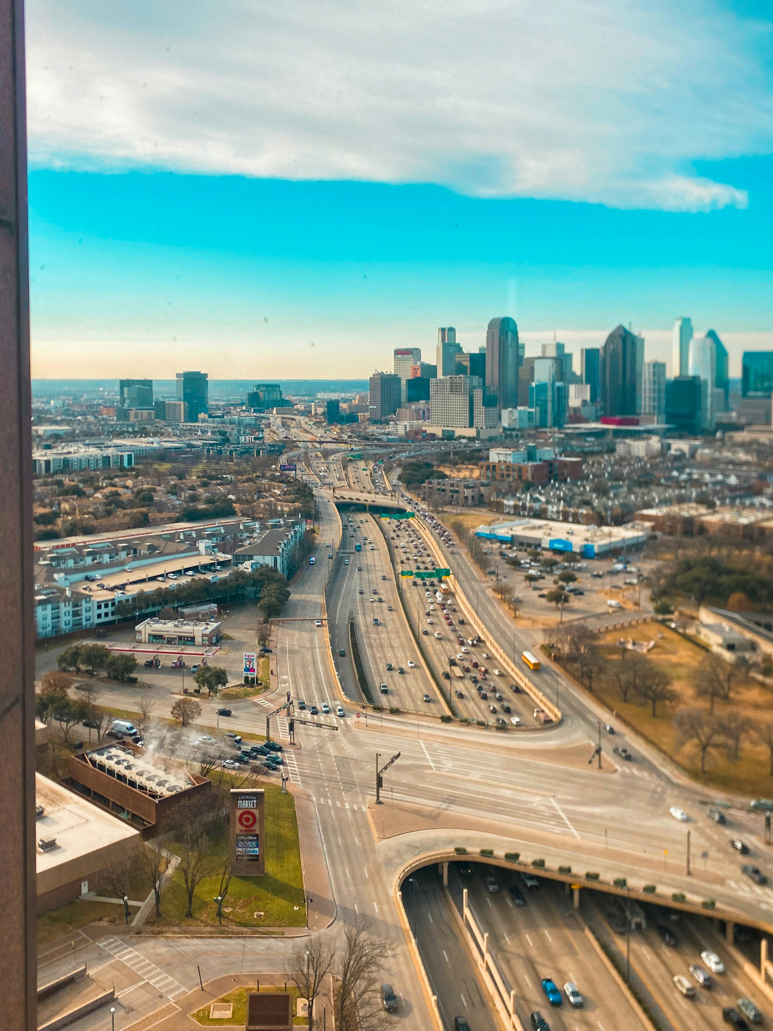 Modern cityscape with a highway and skyscrapers underpass.
