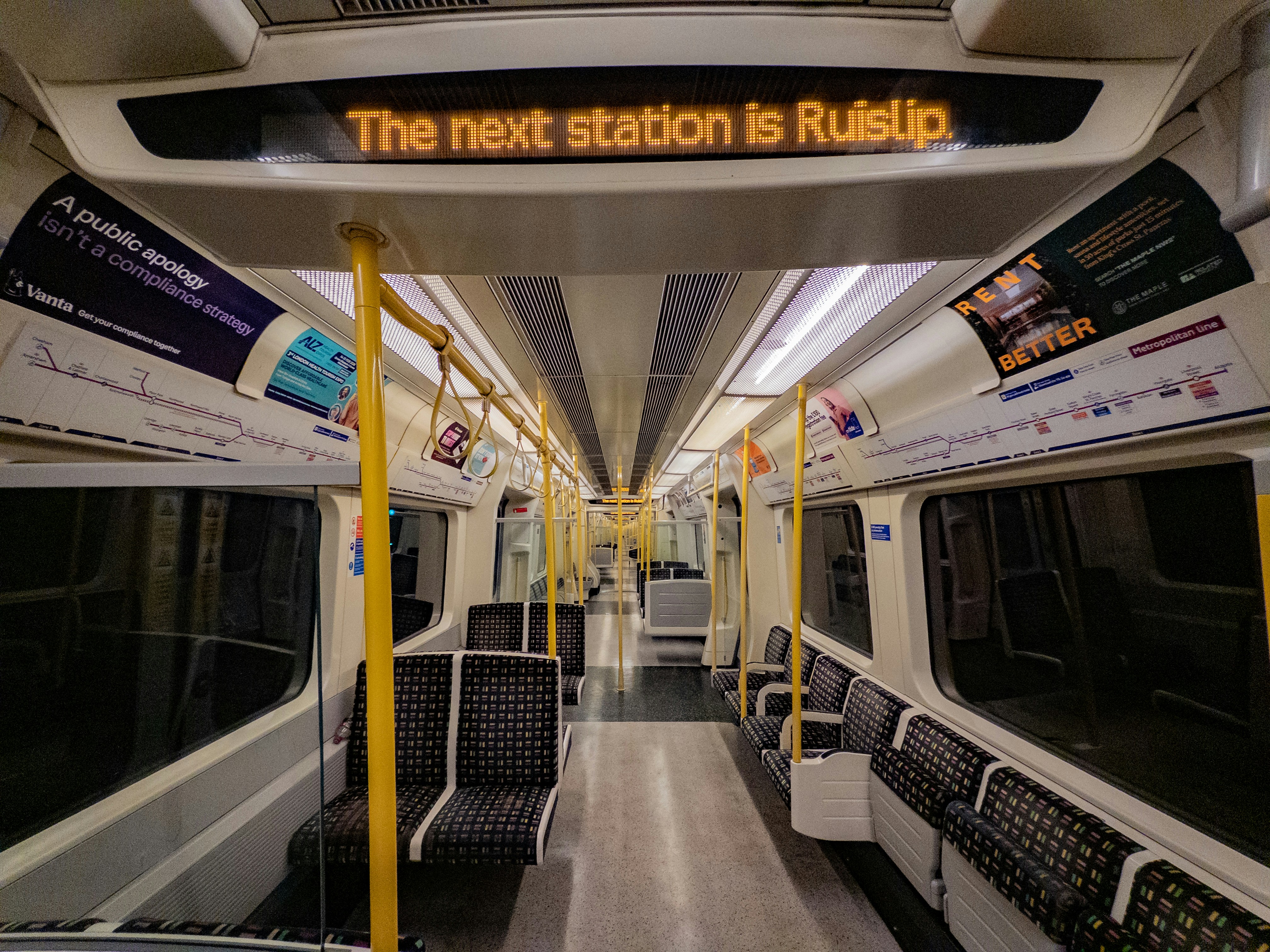 Interior of an empty train car with digital display.