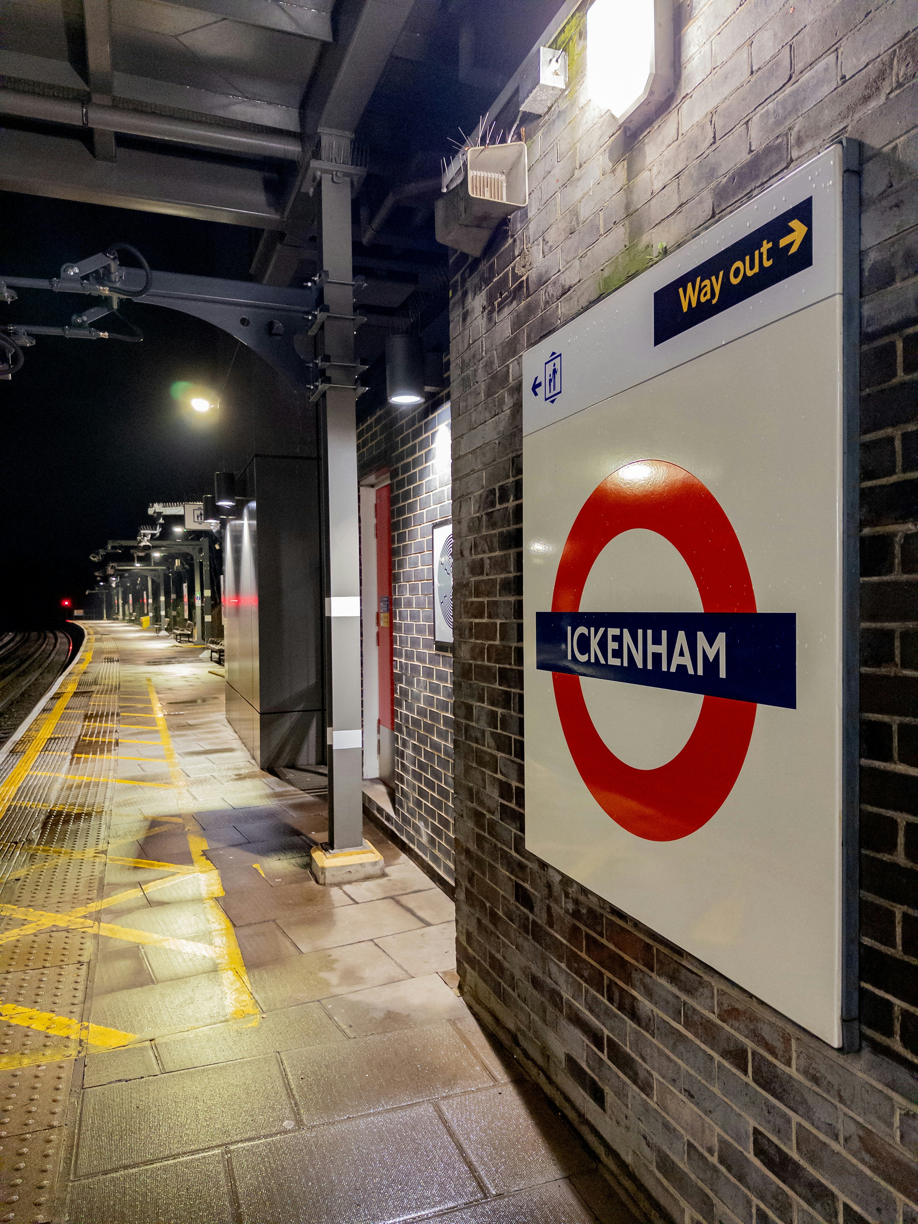 A sign for hounslow station at night