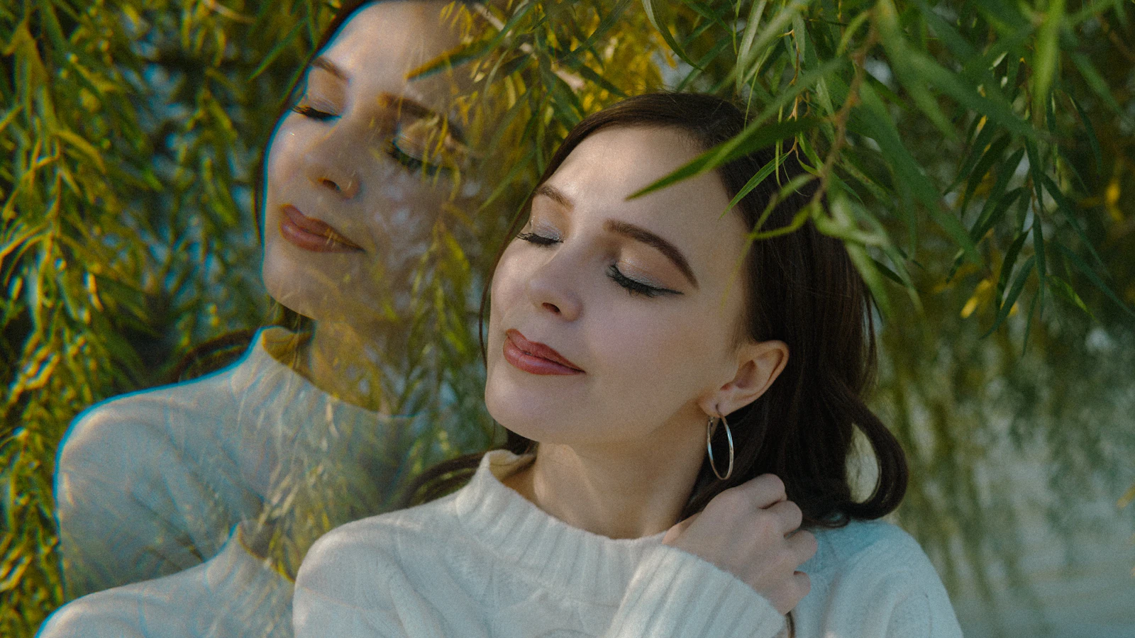 young woman with eyes closed in soft natural light