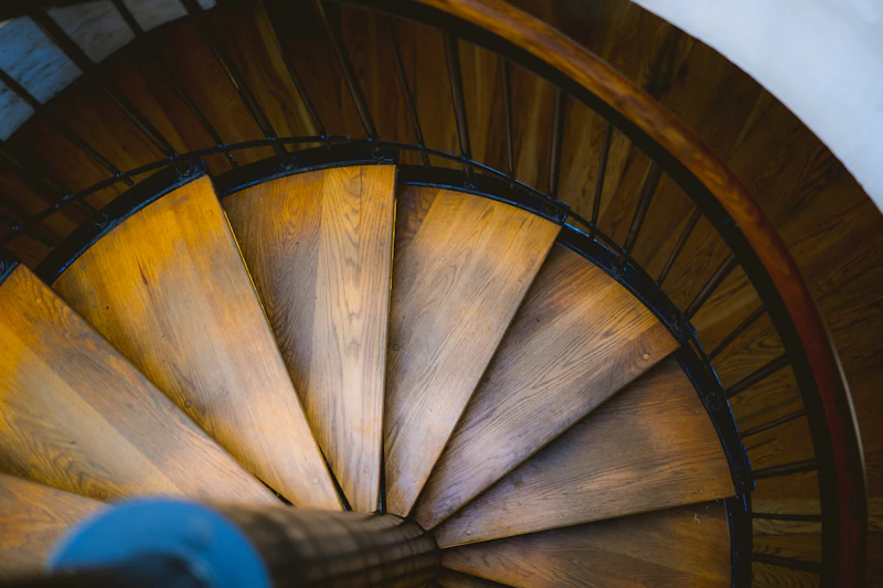 Non Slip Stair Treads in Appleton — Wooden spiral staircase with a metal railing