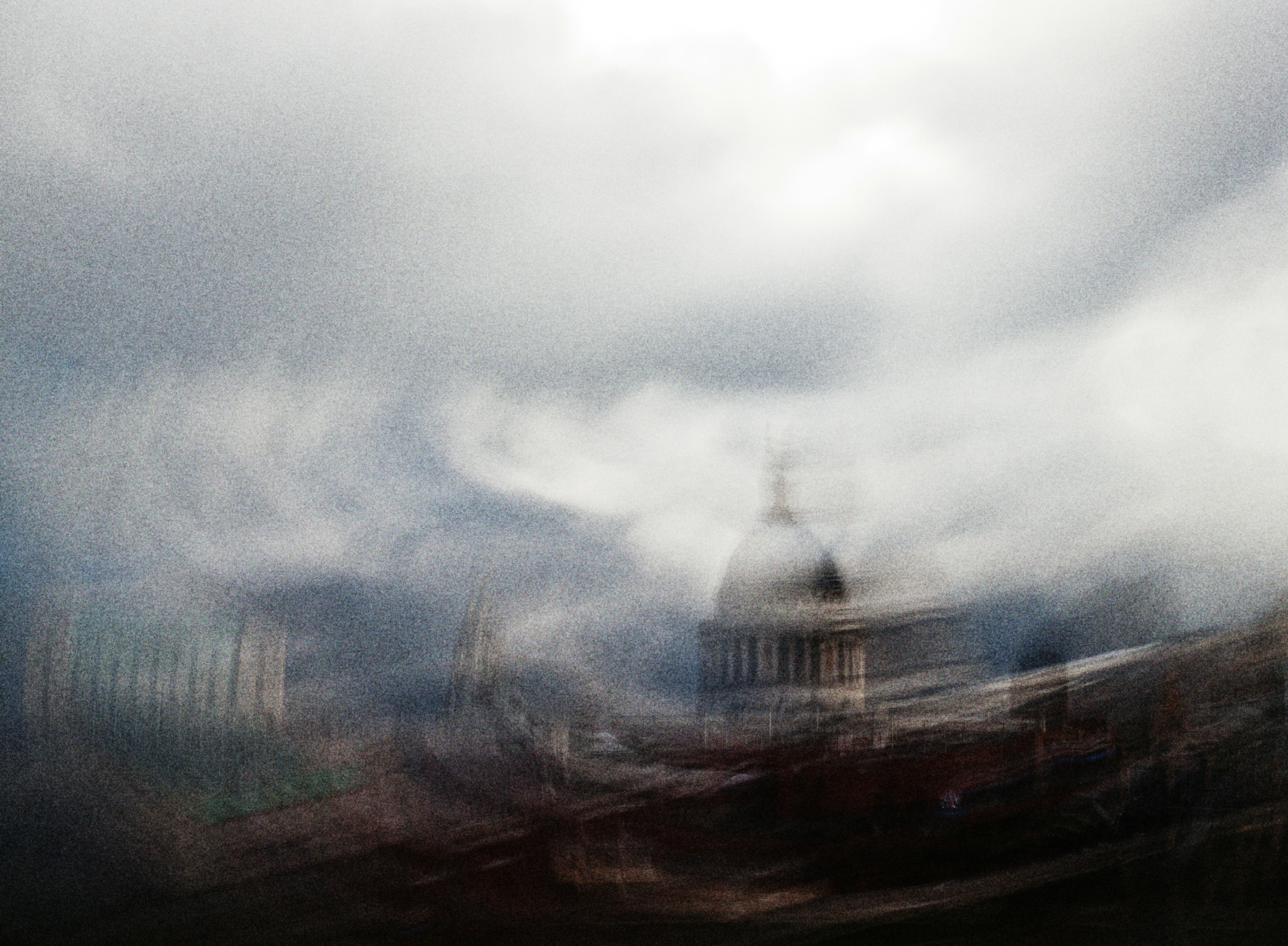 Blurred view of a domed building under cloudy skies