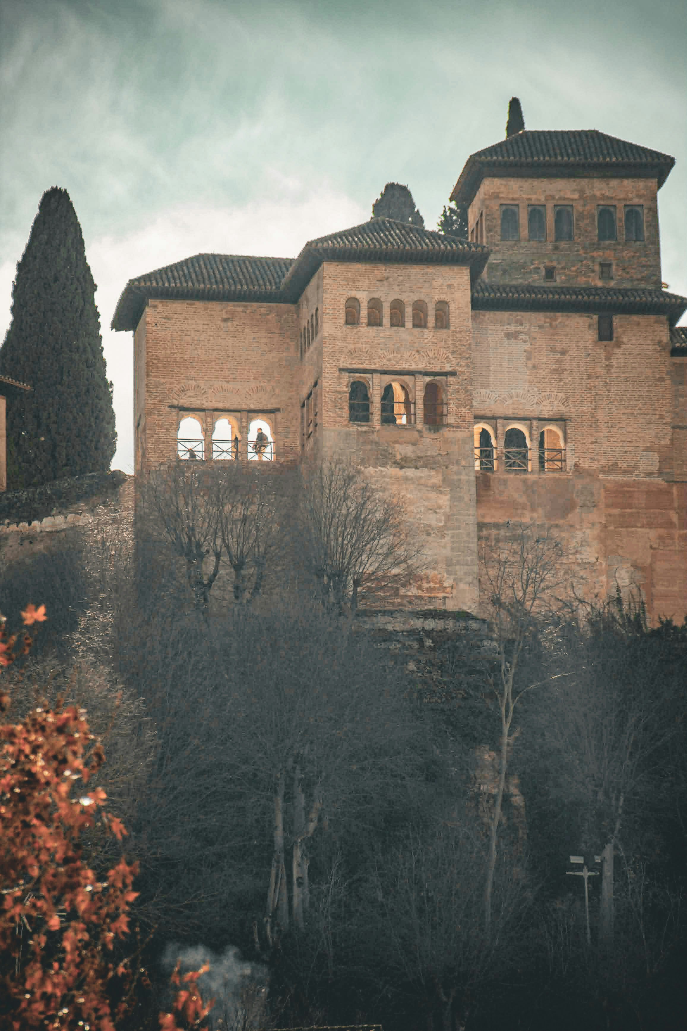 Historic brick building with arched windows on a hill
