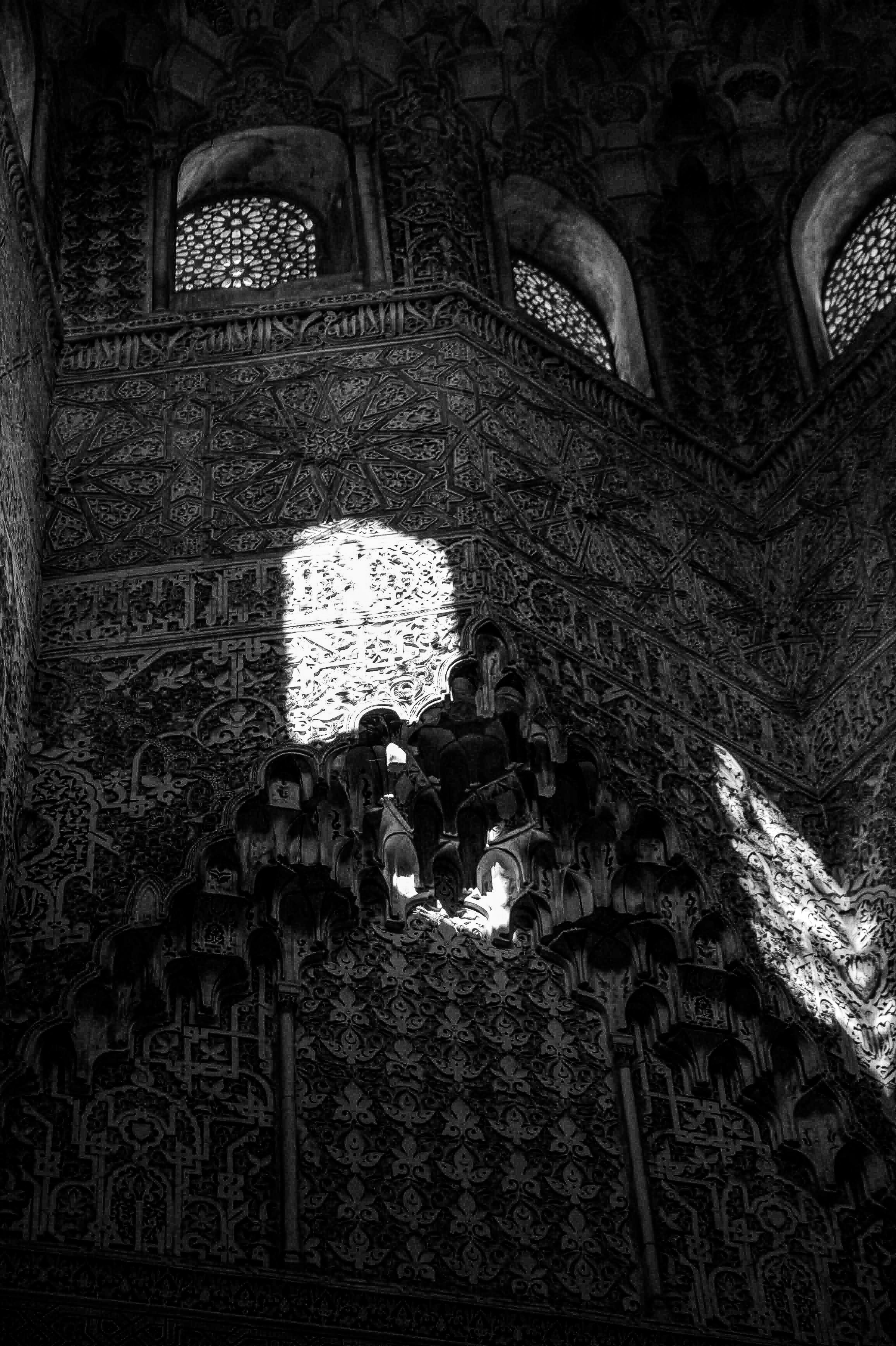 Intricate patterns adorn ancient walls illuminated by sunlight.