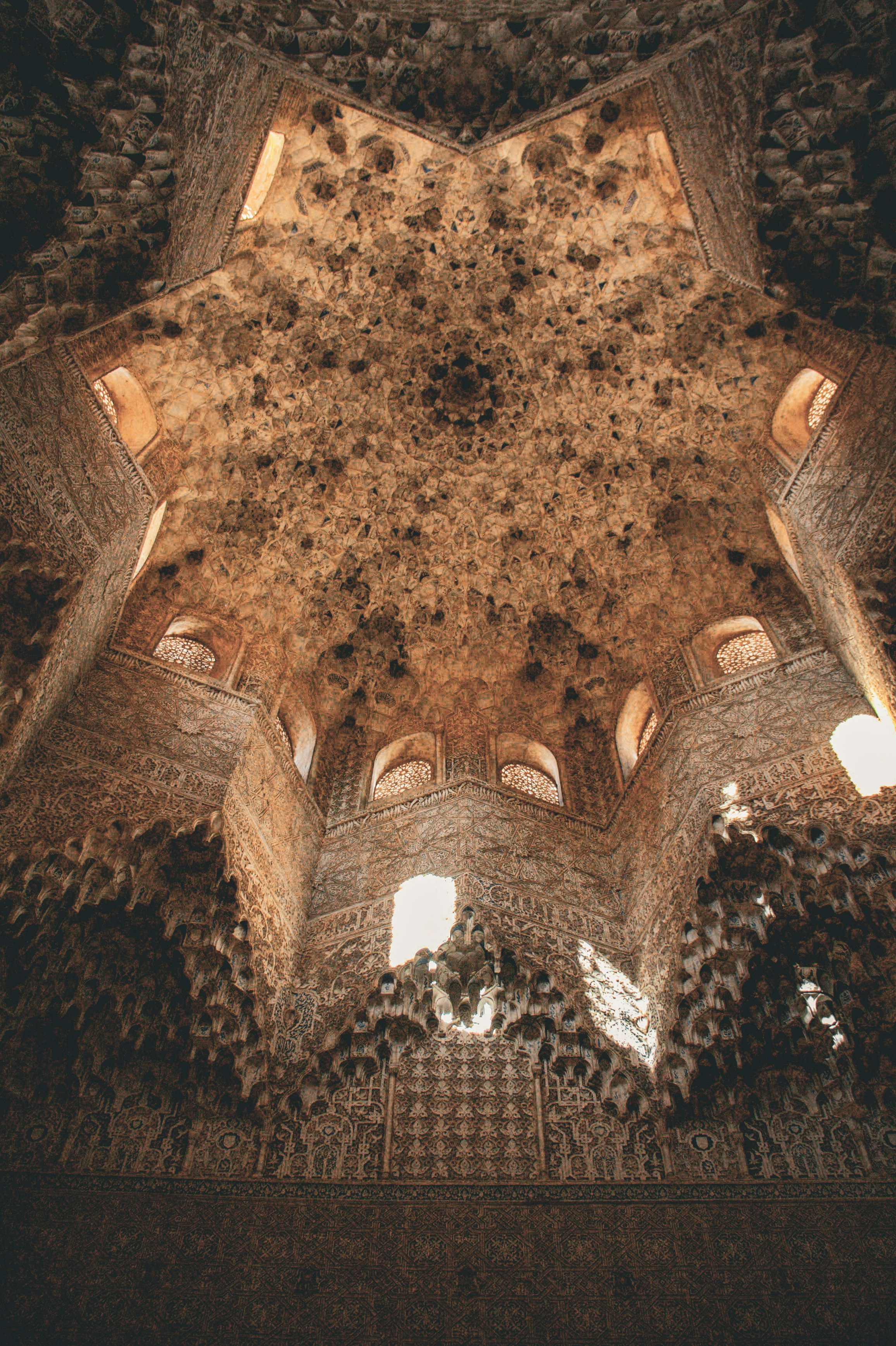 Intricate star-shaped ceiling with ornate carvings and windows