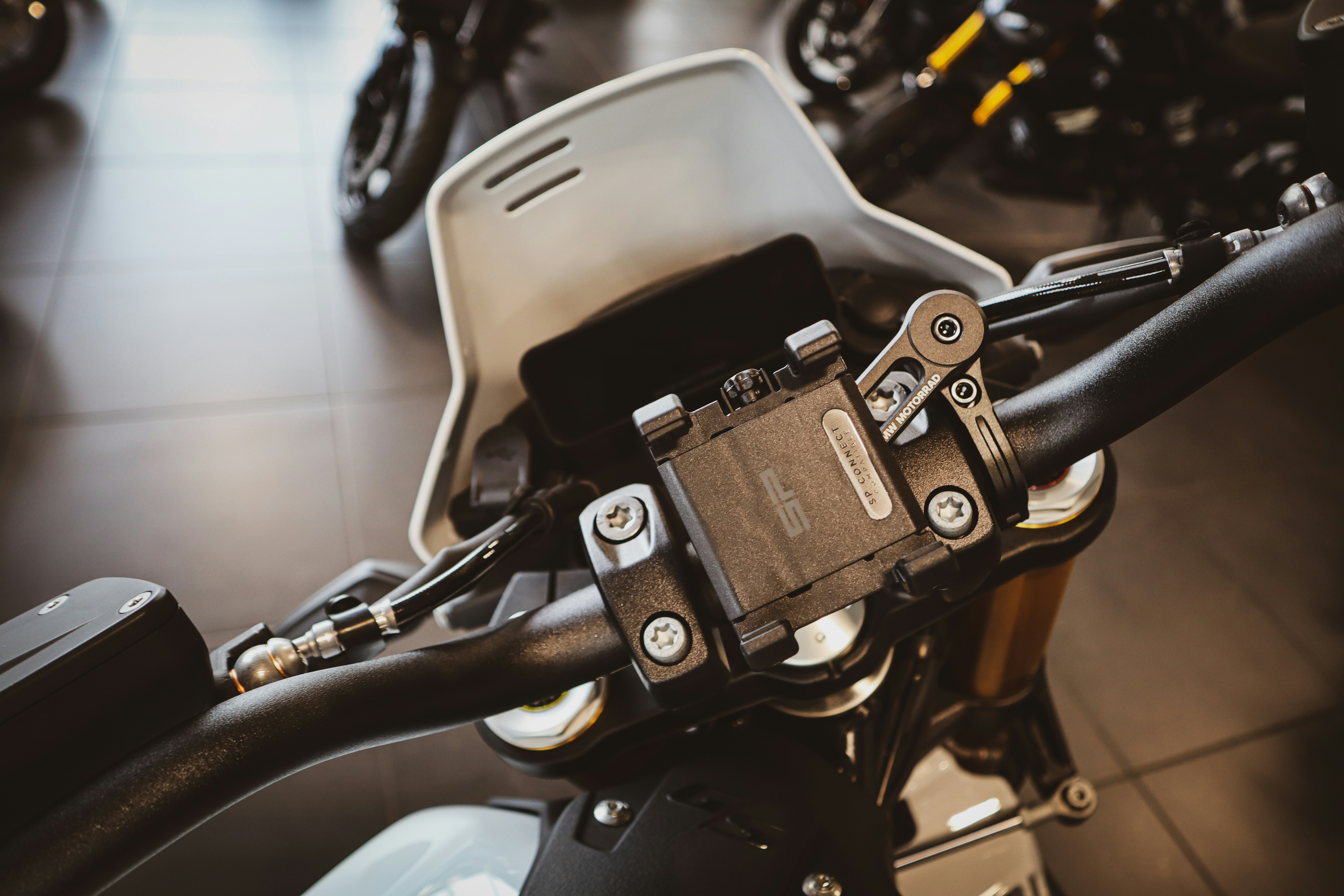 Close-up of a motorcycle's handlebars and dashboard.