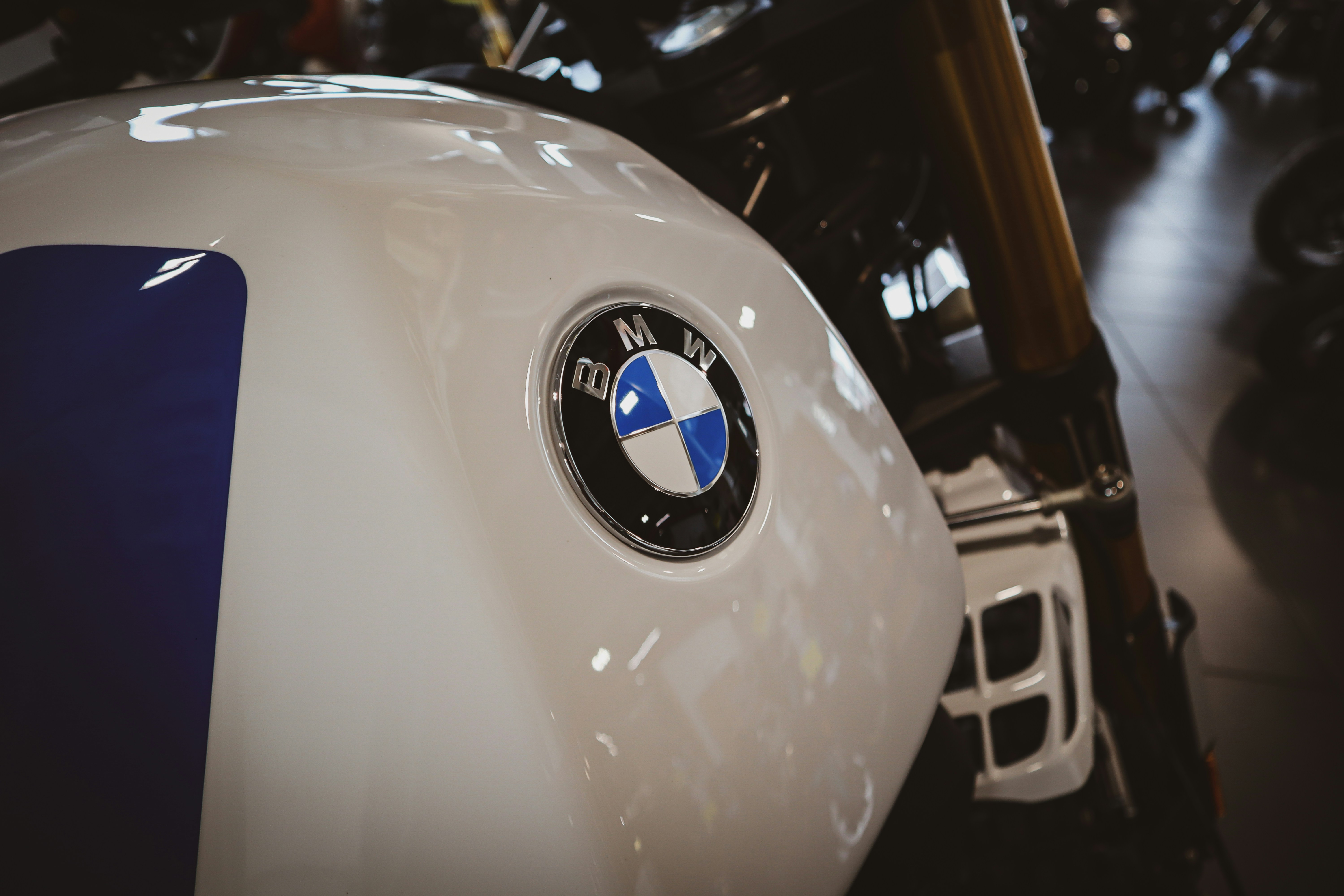 Close-up of a white BMW motorcycle fuel tank.