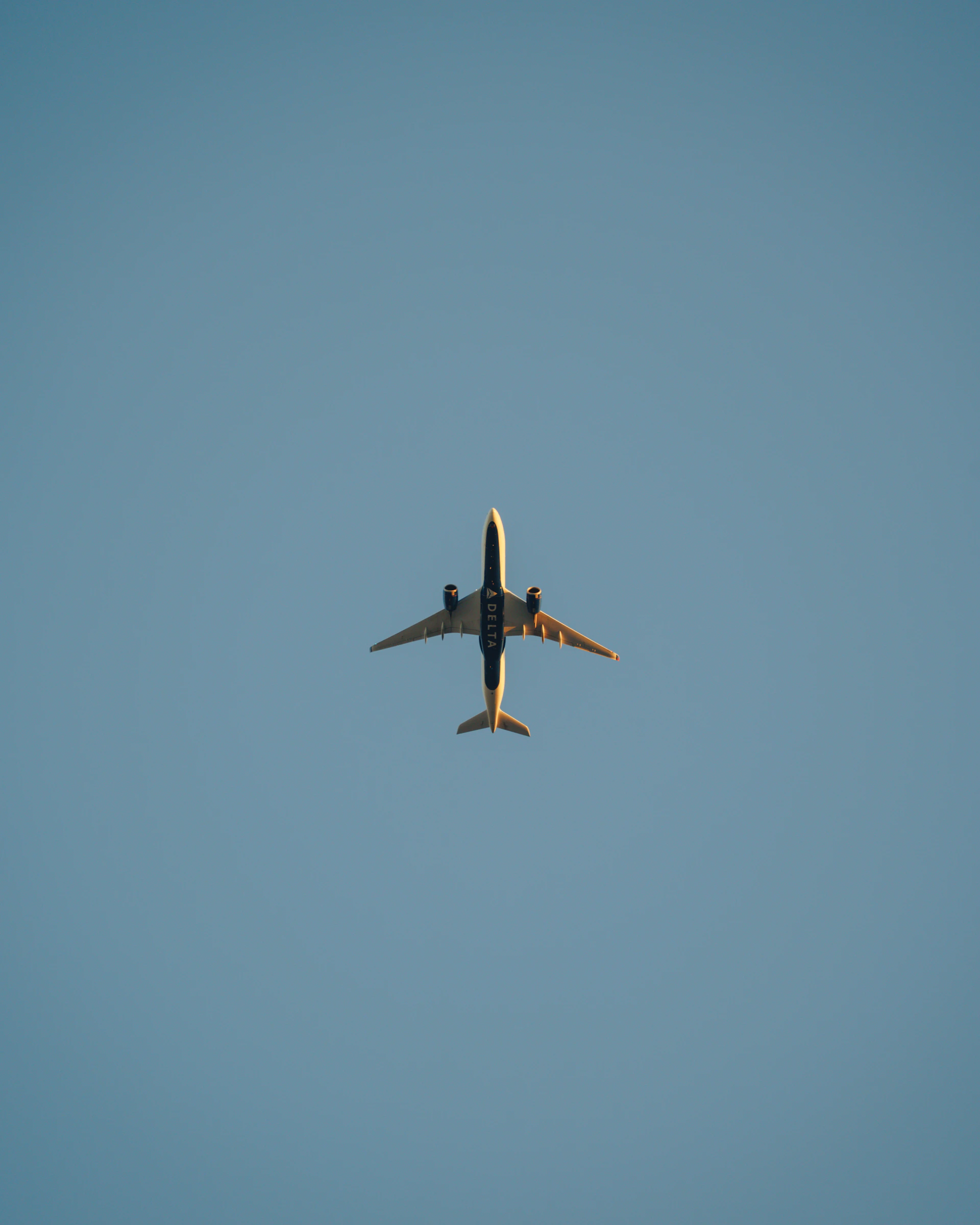 Airplane flying high in a clear blue sky