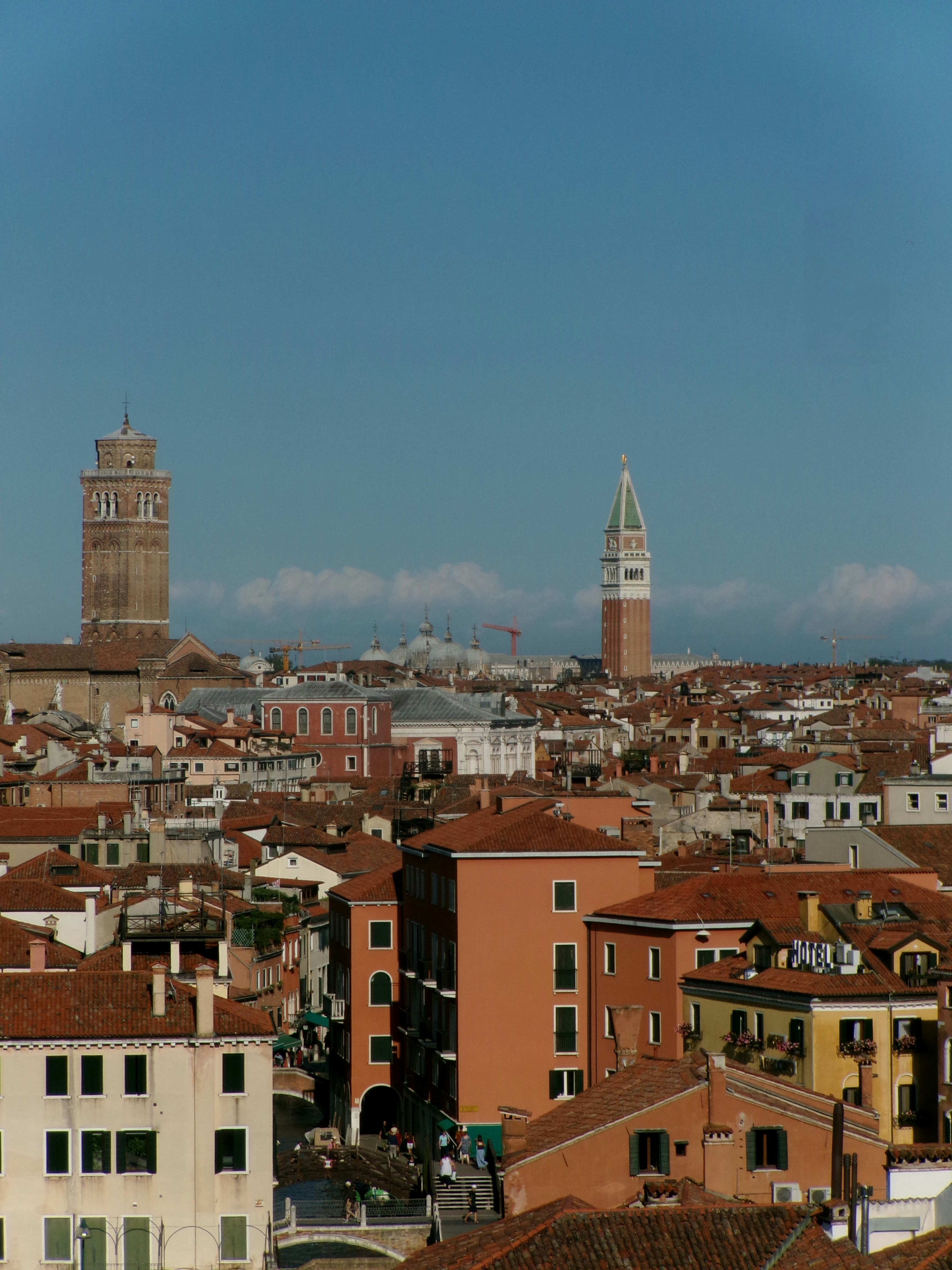 Rooftops and bell towers under a clear blue sky