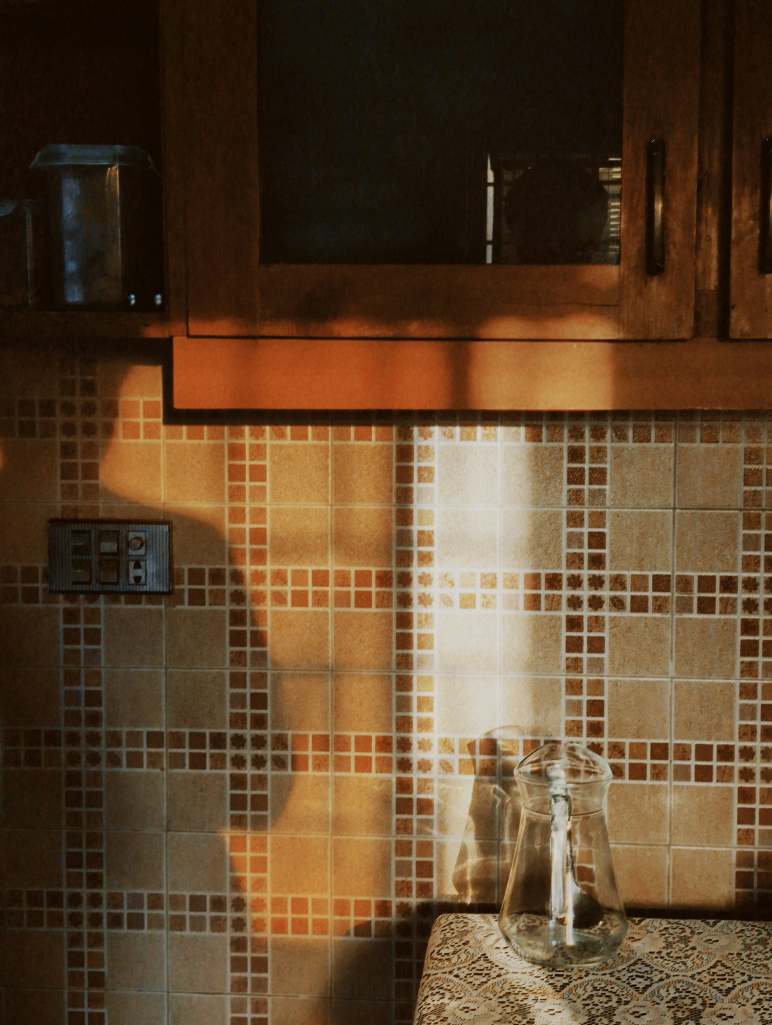 Sunlight across a beautifully tiled kitchen backsplash