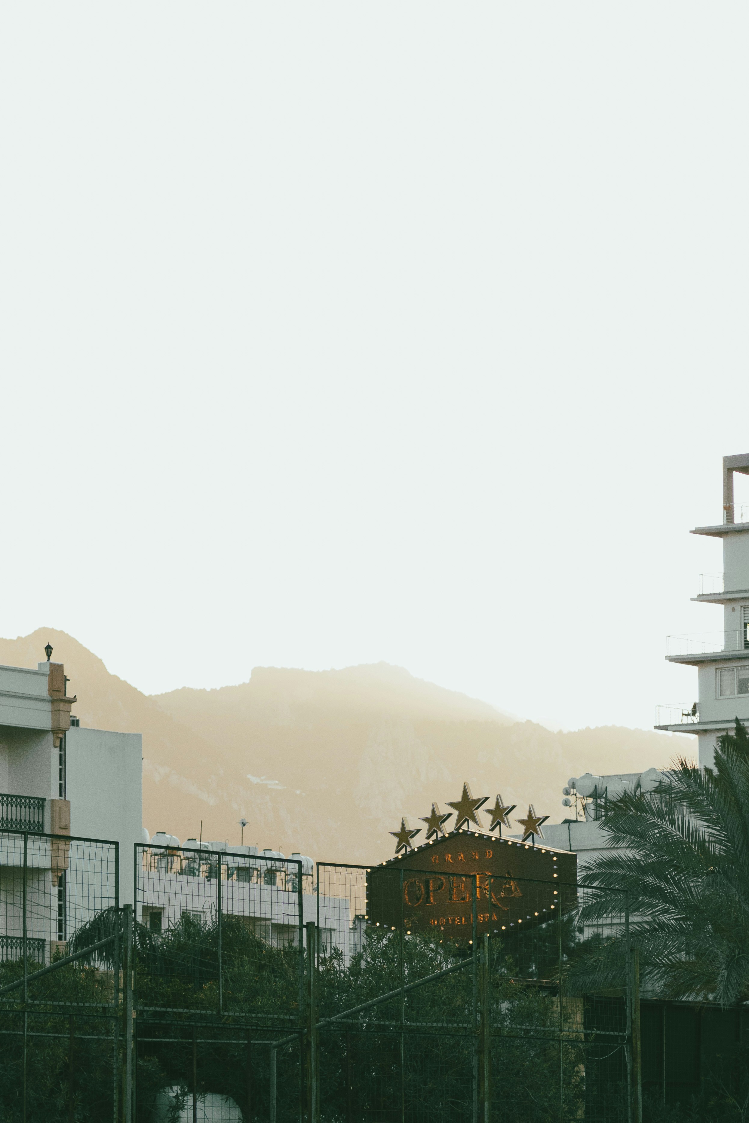 Hotel sign with stars near mountains at sunset