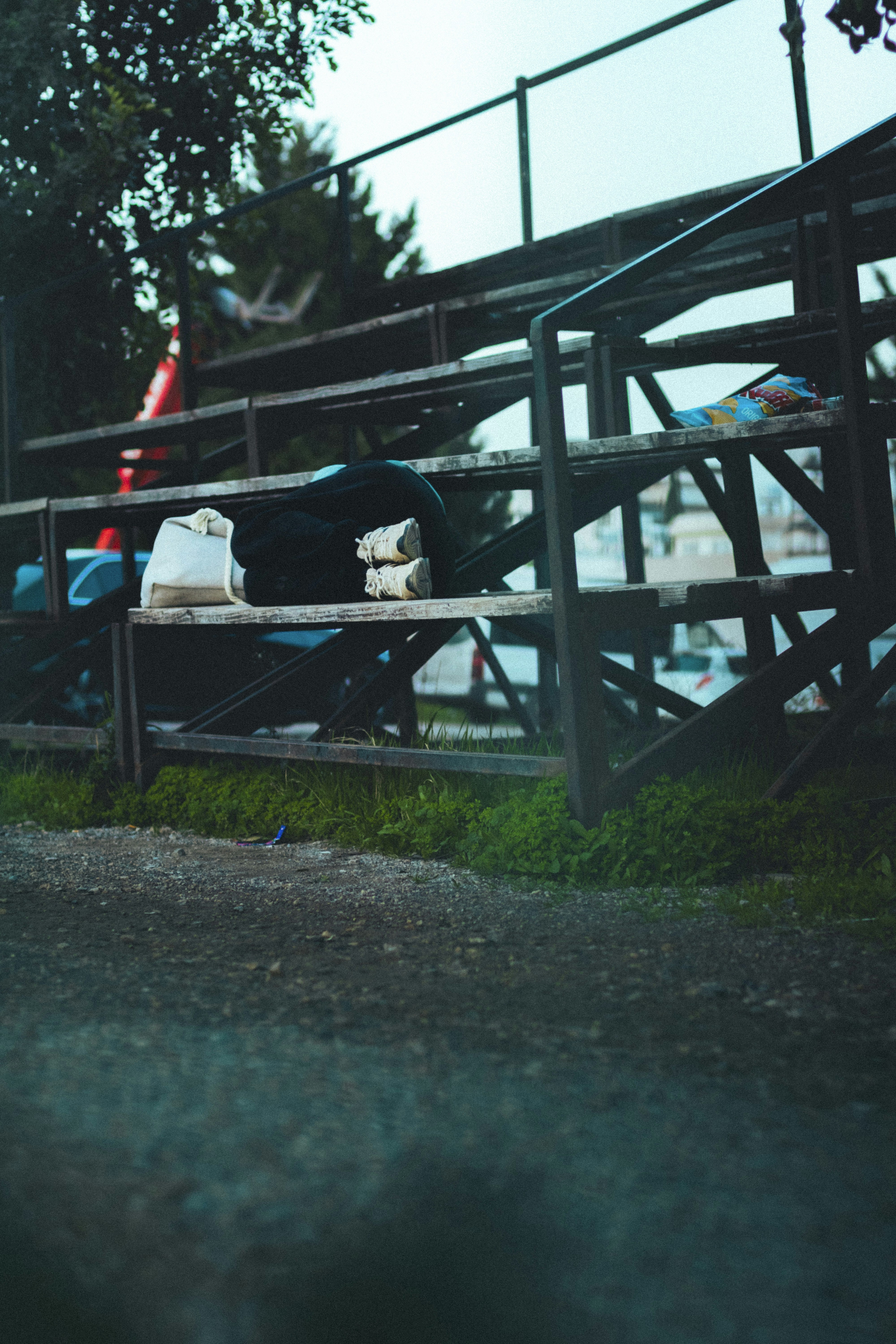 Empty bleachers with bags on a cloudy day